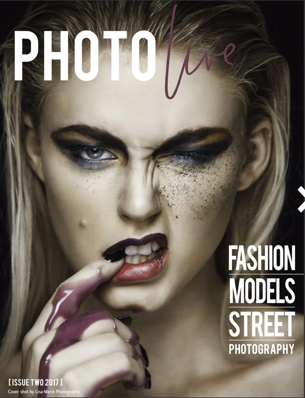 Close-up of a woman with intense makeup, partly licking her finger covered in paint or ink, with the text 'PHOTO live' at the top and 'FASHION MODELS STREET PHOTOGRAPHY' on the right side, and issue information at the bottom.
