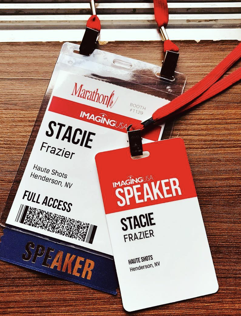 Conference badge and speaker badge for Stacie Frazier at a marathon event, held at Haute Shots in Henderson, NV, with red lanyards on a wooden surface.