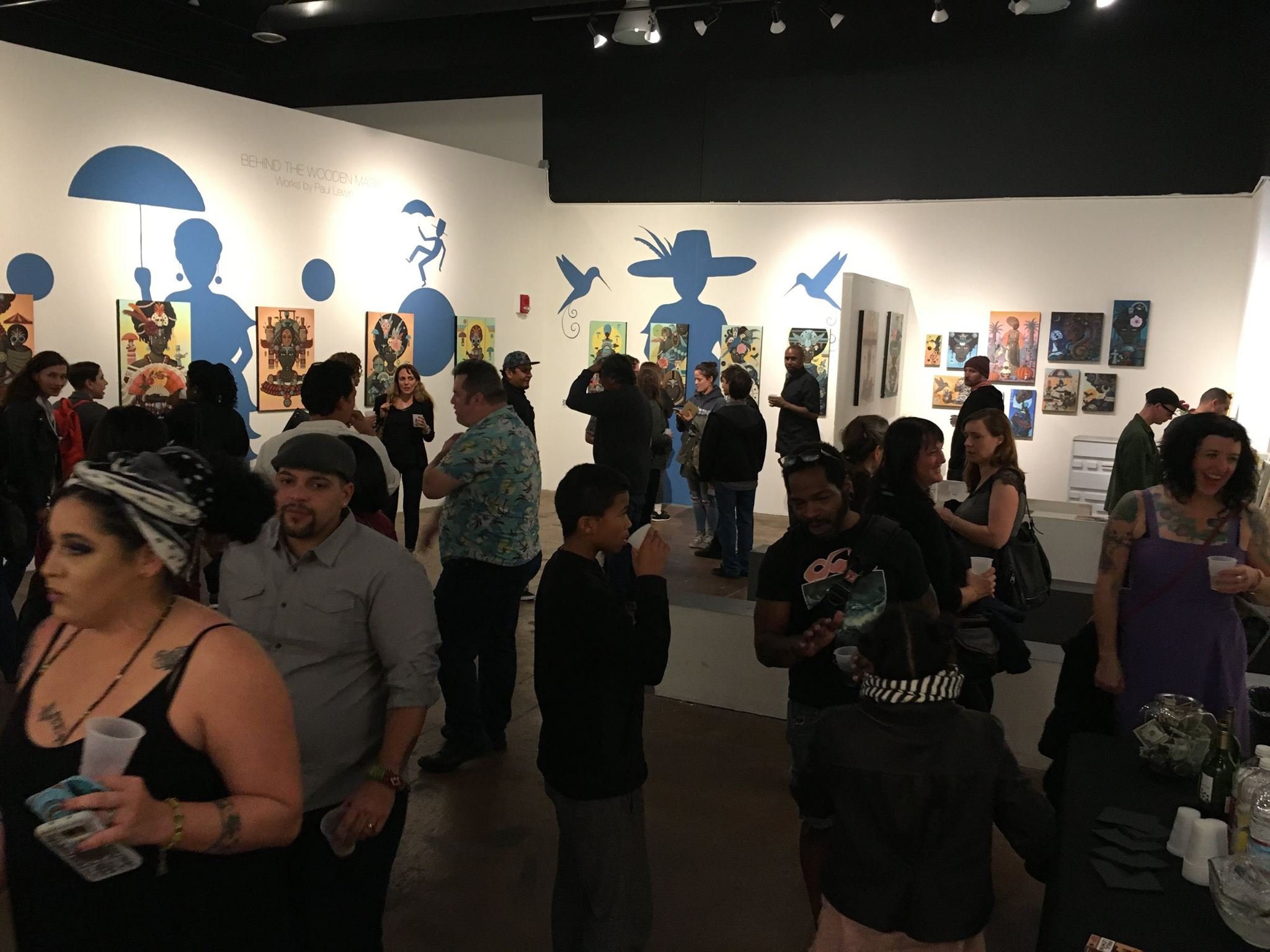  Full crowd filling a room in an art gallery 