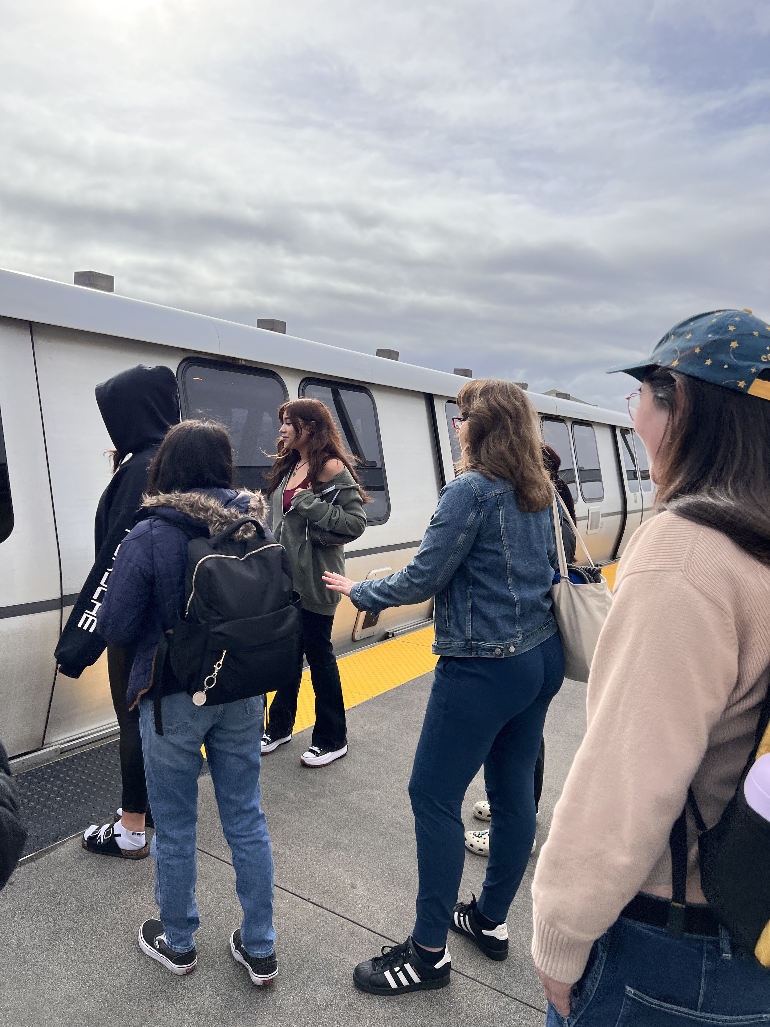  Small group of youth waiting to enter a BART train 