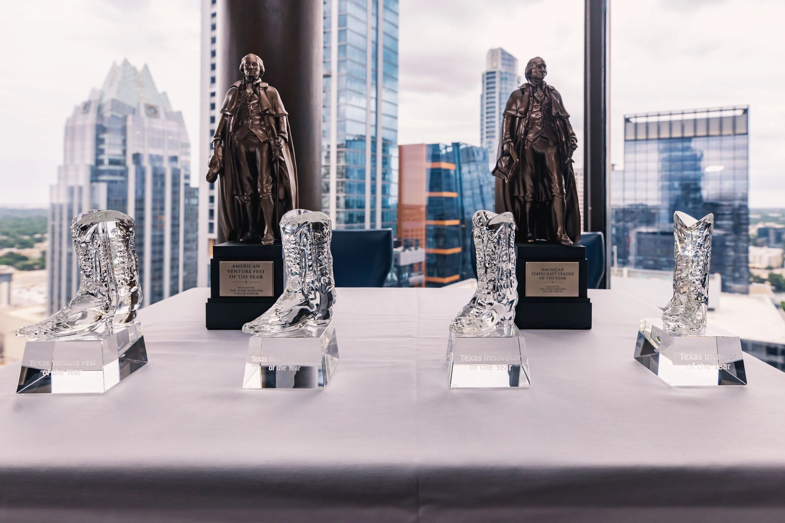 Texas Venture Gala & Forum Awards are displayed on a table.