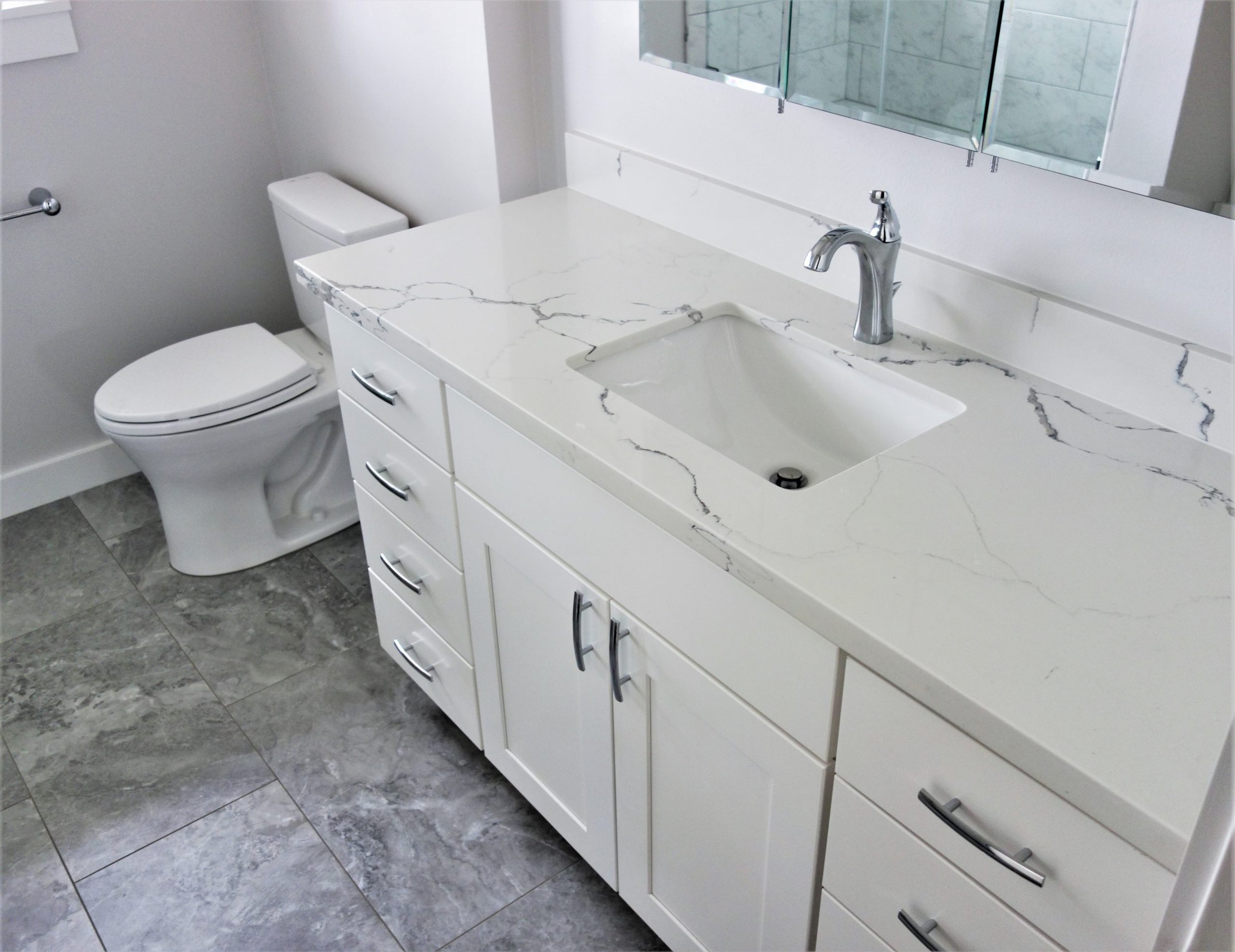 Guest-Bathroom-Remodel-Quartz-Counters-with-Shaker-Doors-and-Slab-Drawer-Fronts-scaled.jpg