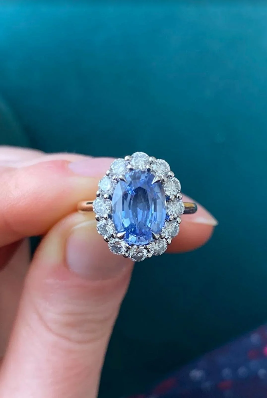 Blue sapphire and diamond halo bespoke engagement ring