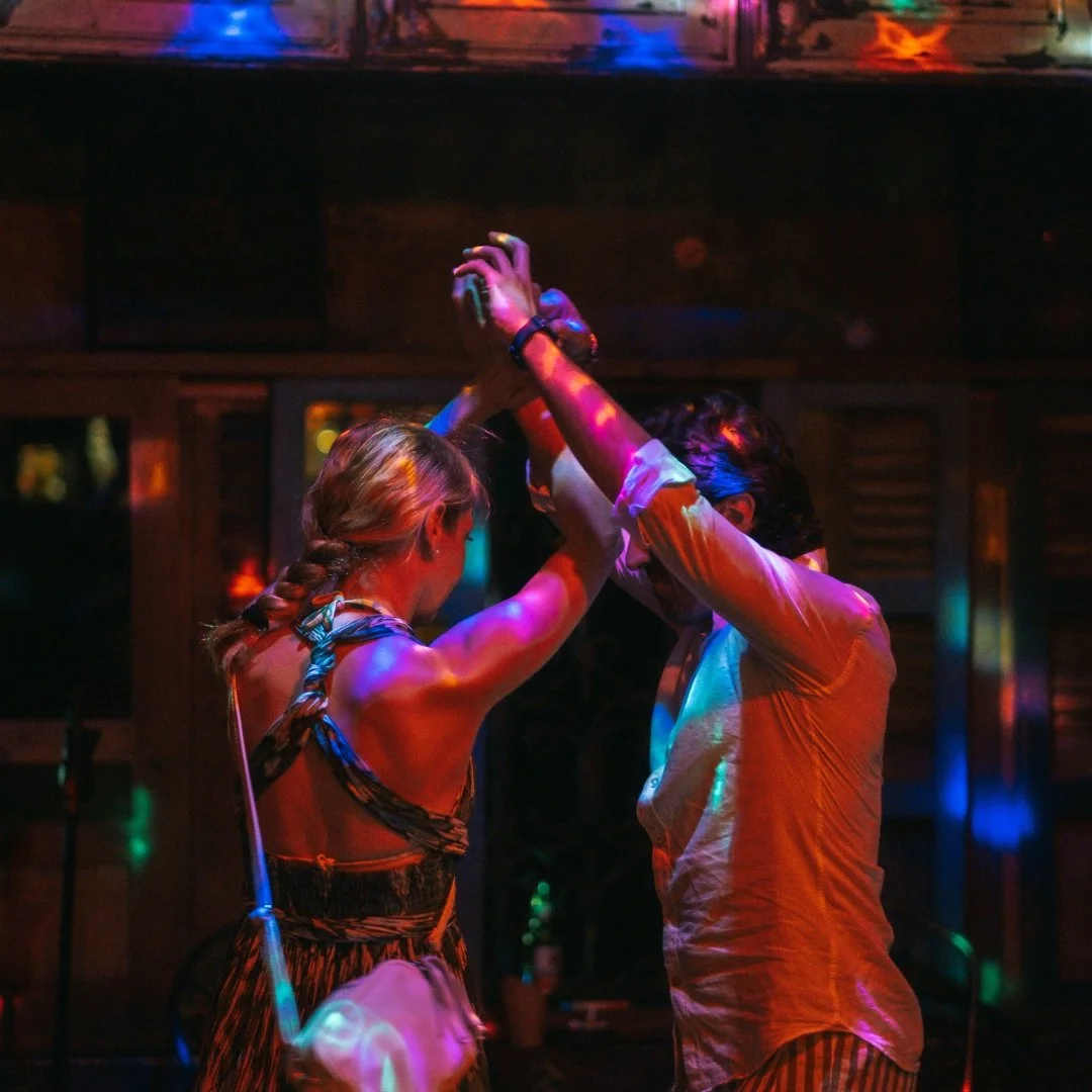 a couple enjoying a night out doing latin dancing at no más bar