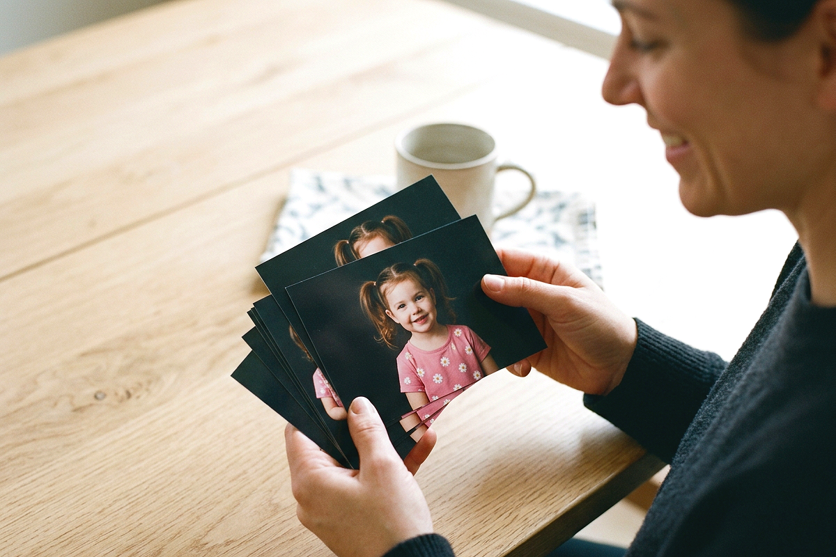 Parent looking through printed school portraits