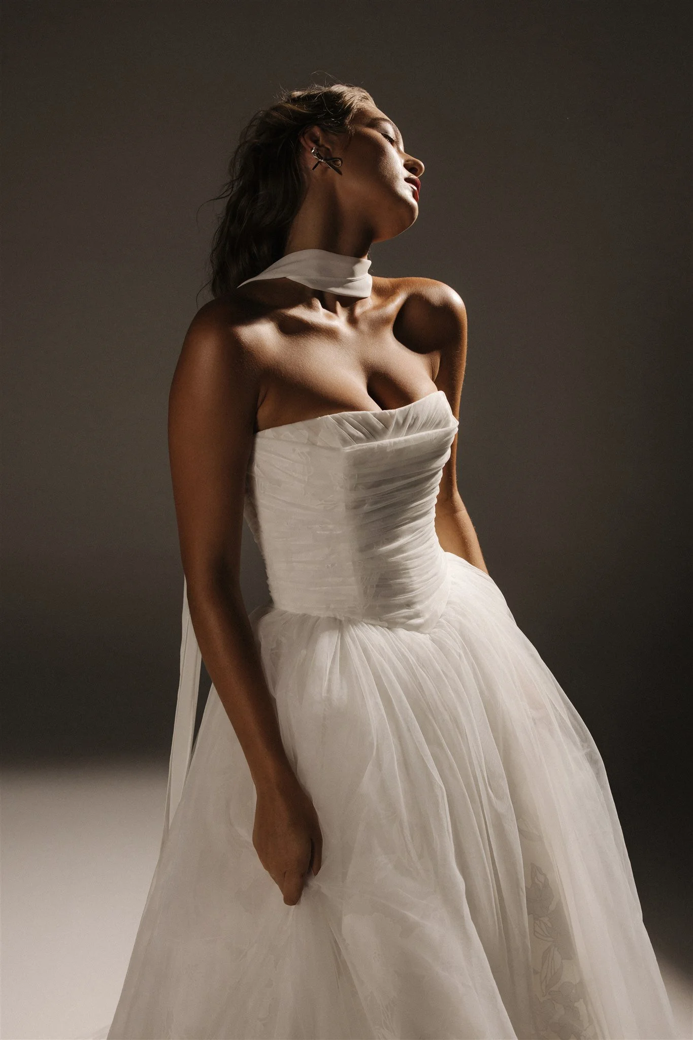 Woman in white off-shoulder wedding dress outdoors