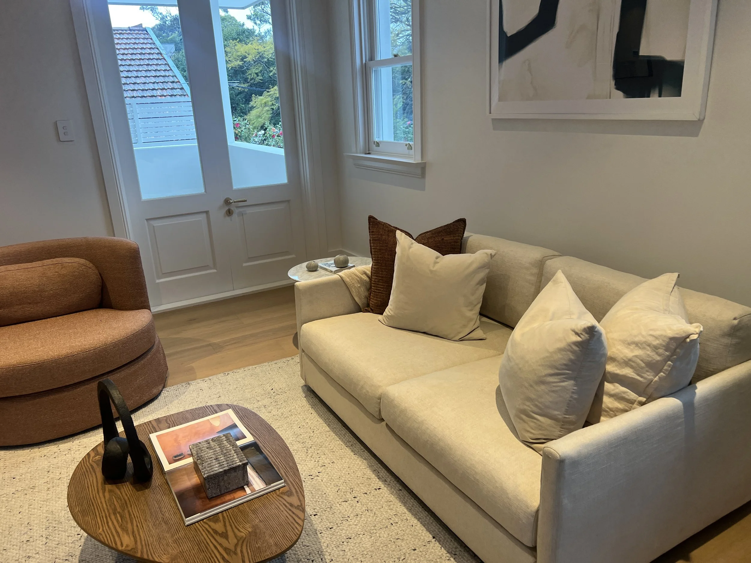 Sitting room as first styled by another company, with a rust swivel chair, Northbridge