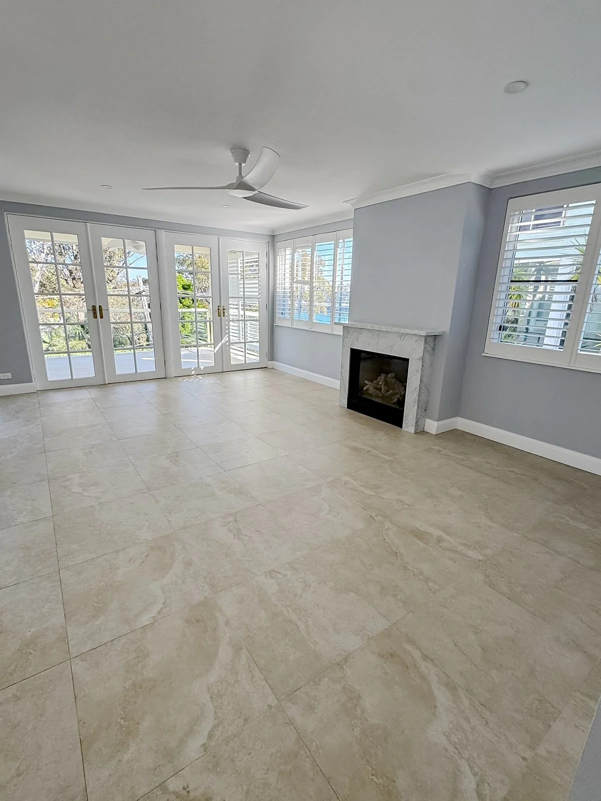 Before styling: empty living room with tiled floors and a fireplace, Clontarf