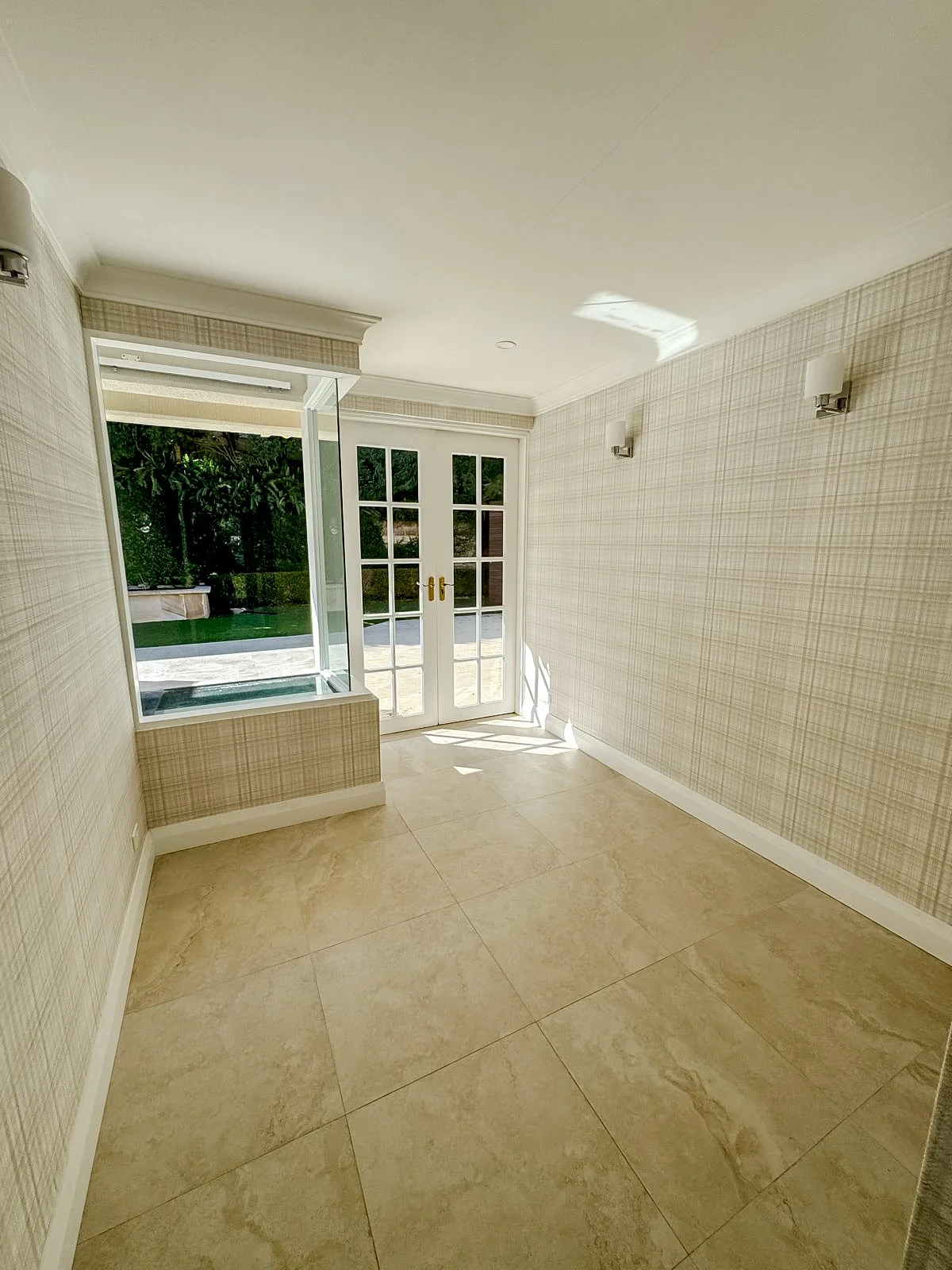 Before styling: empty room with textured wallpaper and doors to the garden, Clontarf