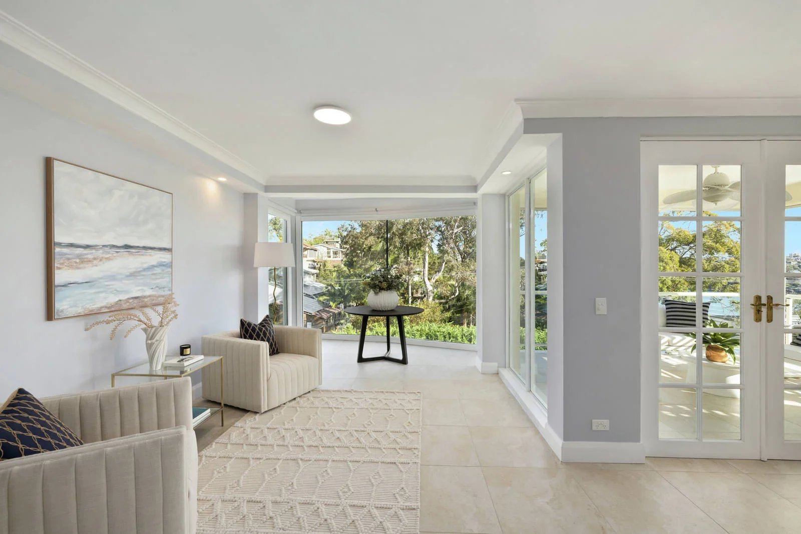 Living room styled for sale with chairs turned to the water views, Clontarf