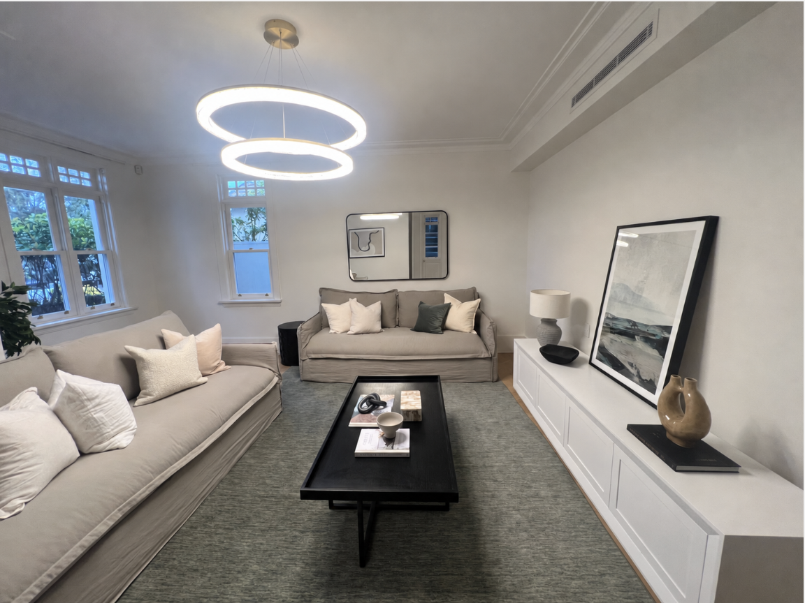Living room as first styled by another company, with facing slipcovered sofas, Northbridge