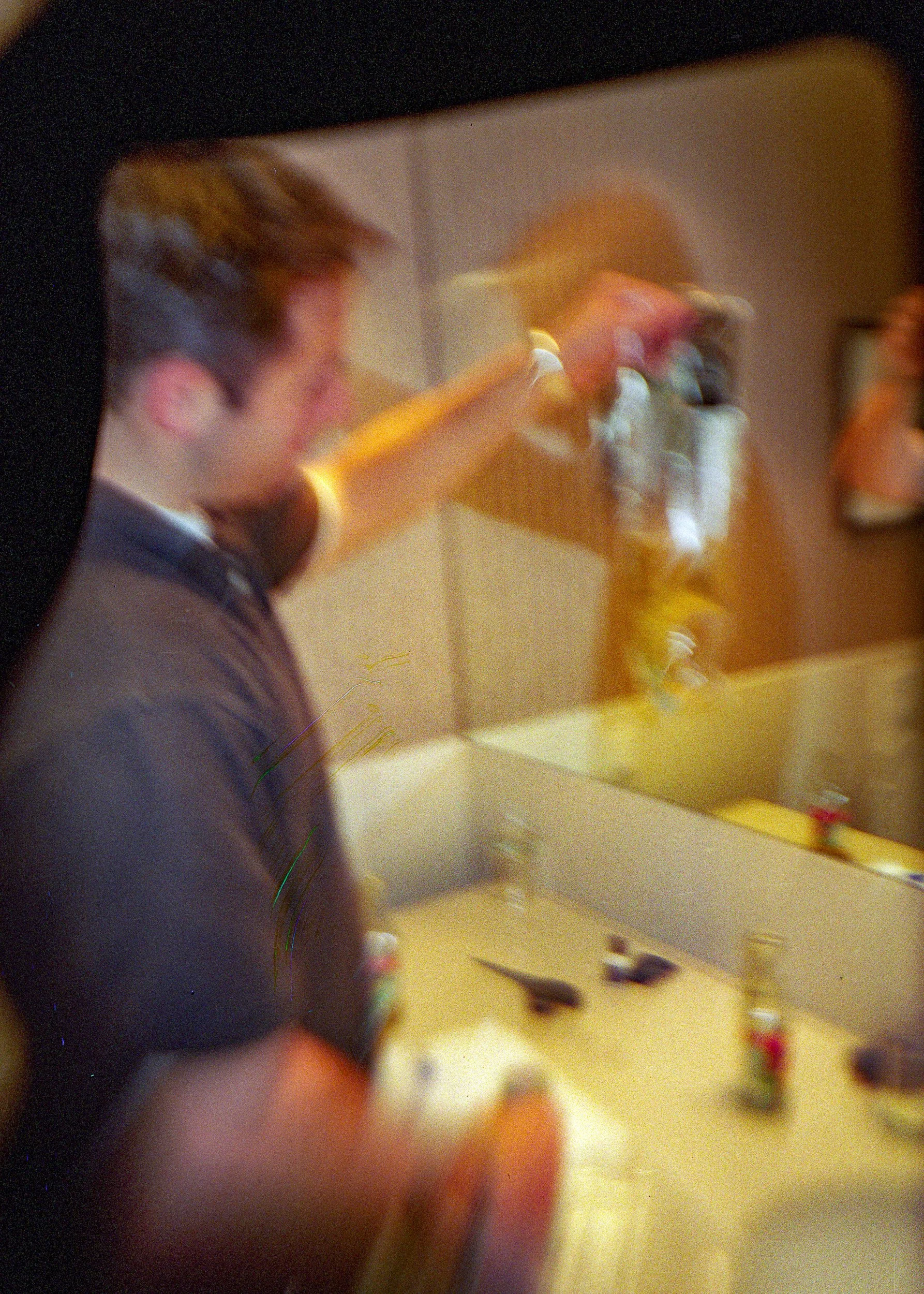 Joe holding a urinary continence bag in a bathroom in Karlsruhe.  (Film slipped the sprockets in the camera.)
