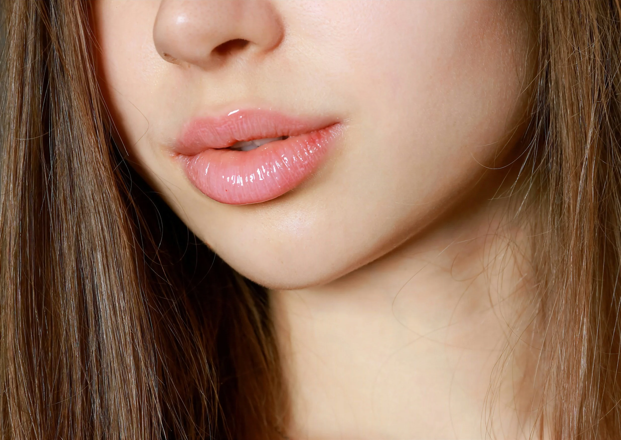 Image of lower half of a womans face with healthy, plump lips