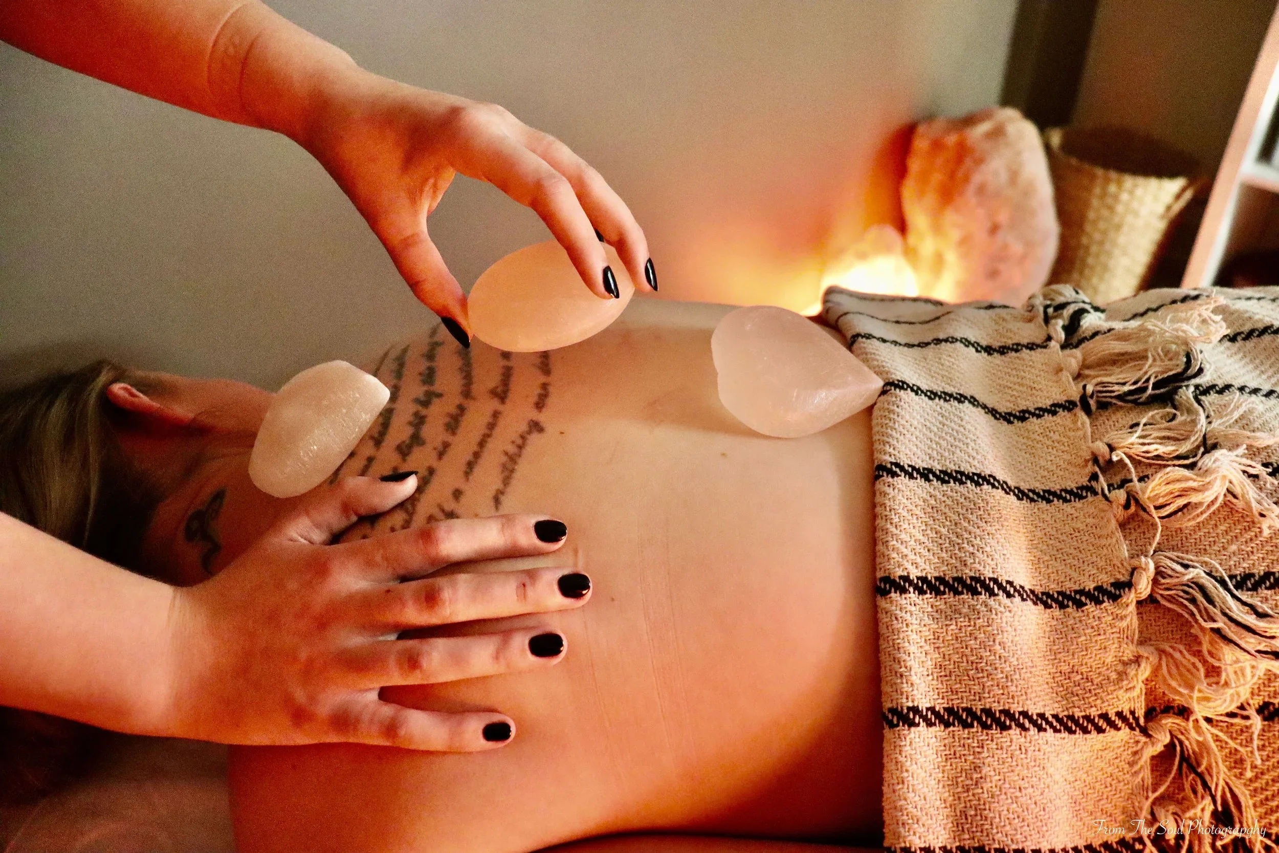 Nordic salt stone massage using warm Himalayan stones at Søle Nordic Wellness in Leduc, Alberta