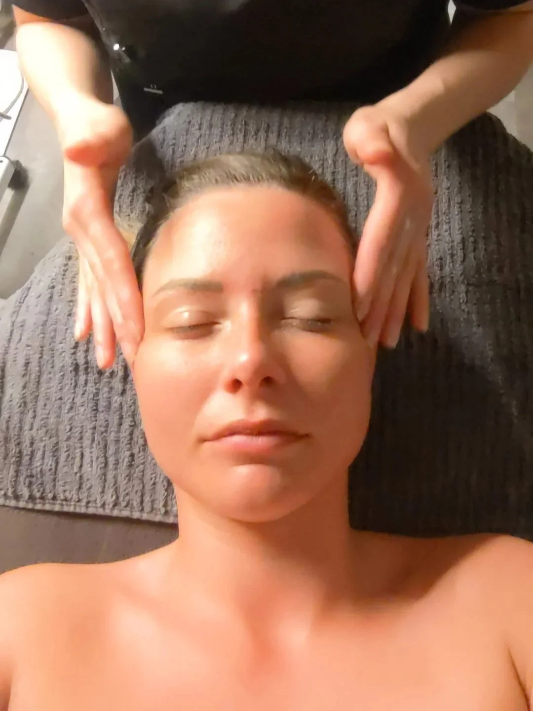 Woman relaxing with glowing skin after her Hydrat facial