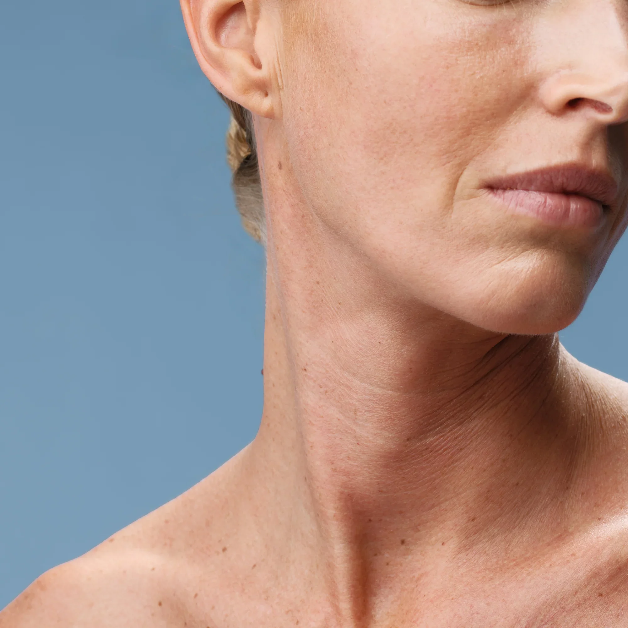 woman's neck and decollete with words firming & toning - 100% of women find their skin smoother