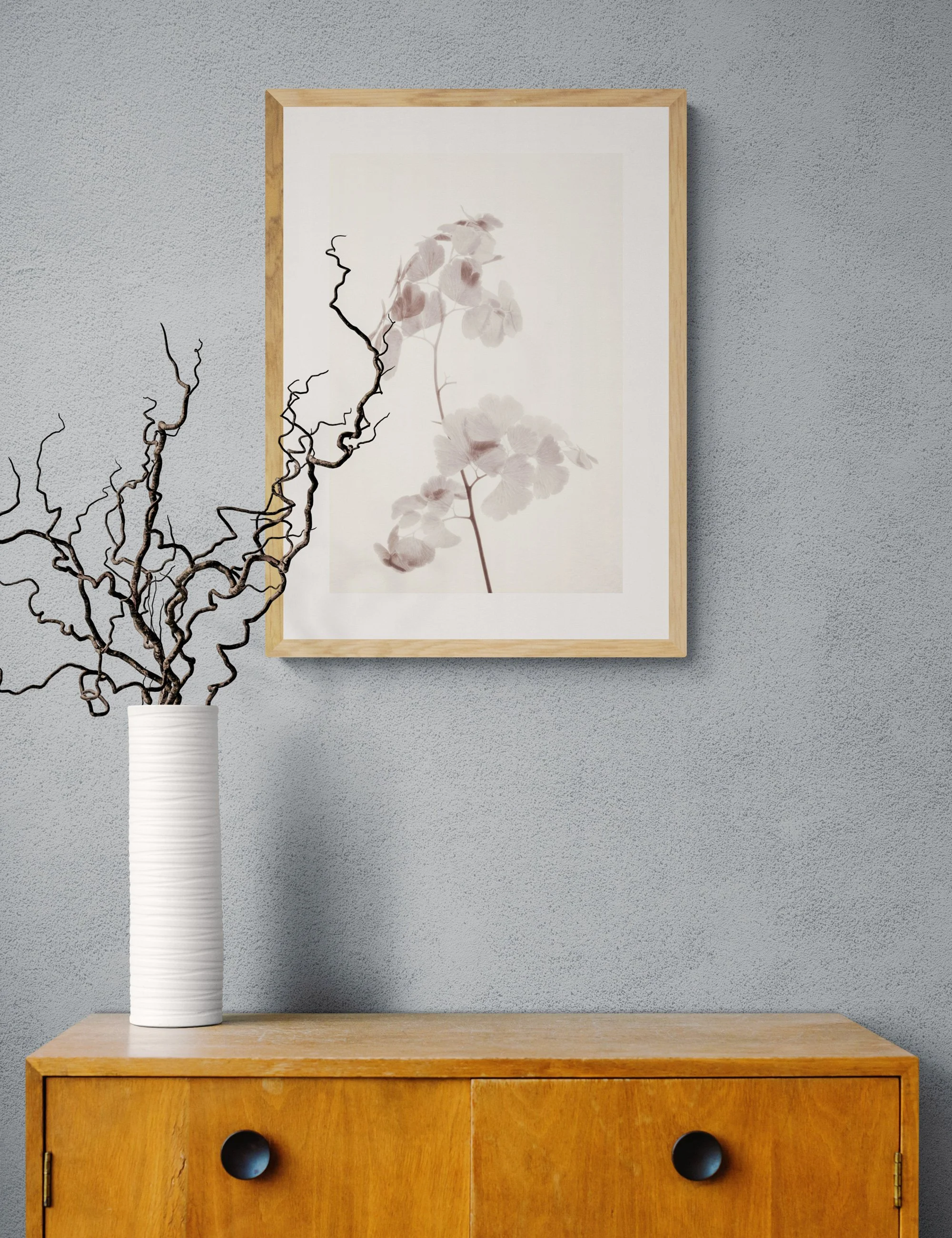 “The Space Between” from the Fronded Forms fern series by Ian J. Muirhead Arts, displayed in a minimalist interior with a light timber frame and sculptural branches.