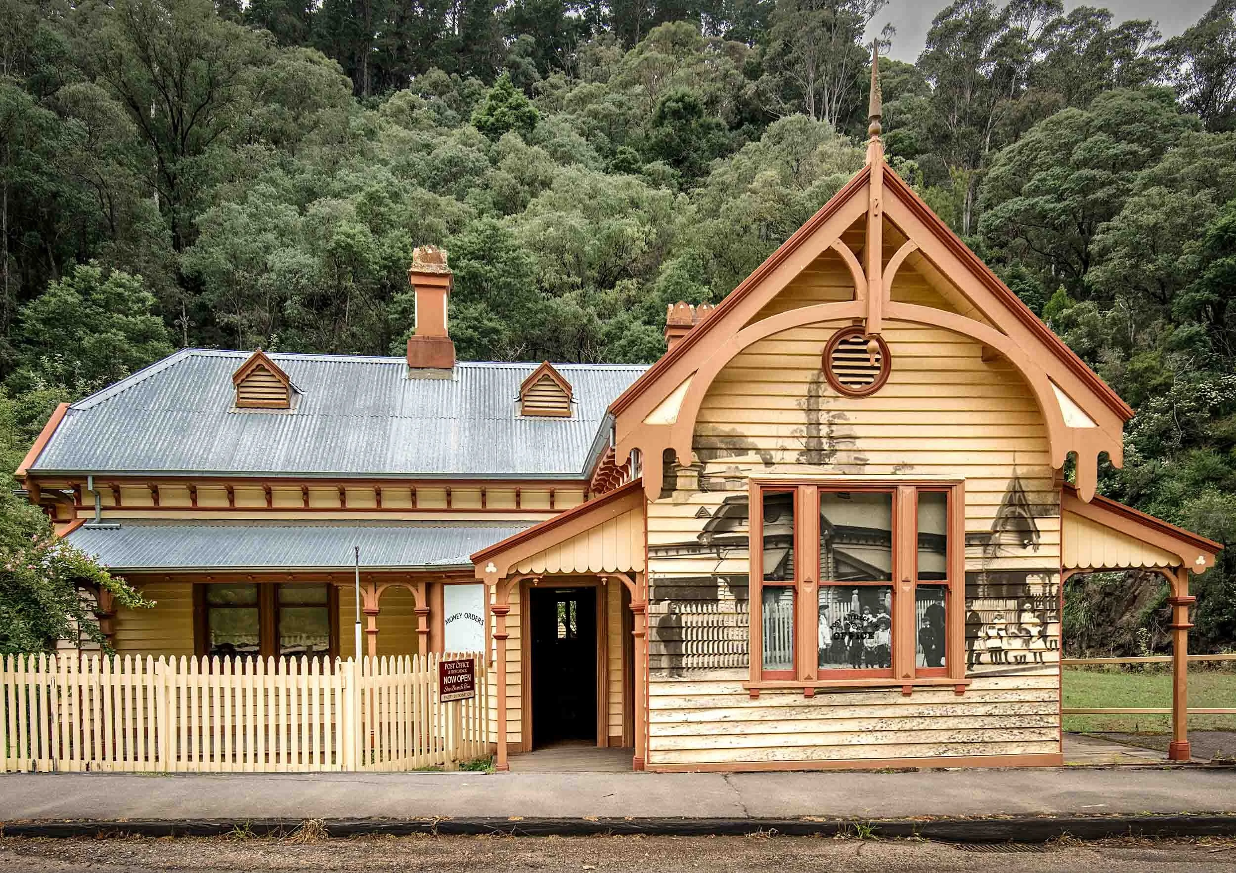 Old Walhalla Post Office Museum with historic street scene superimposed on its facade.