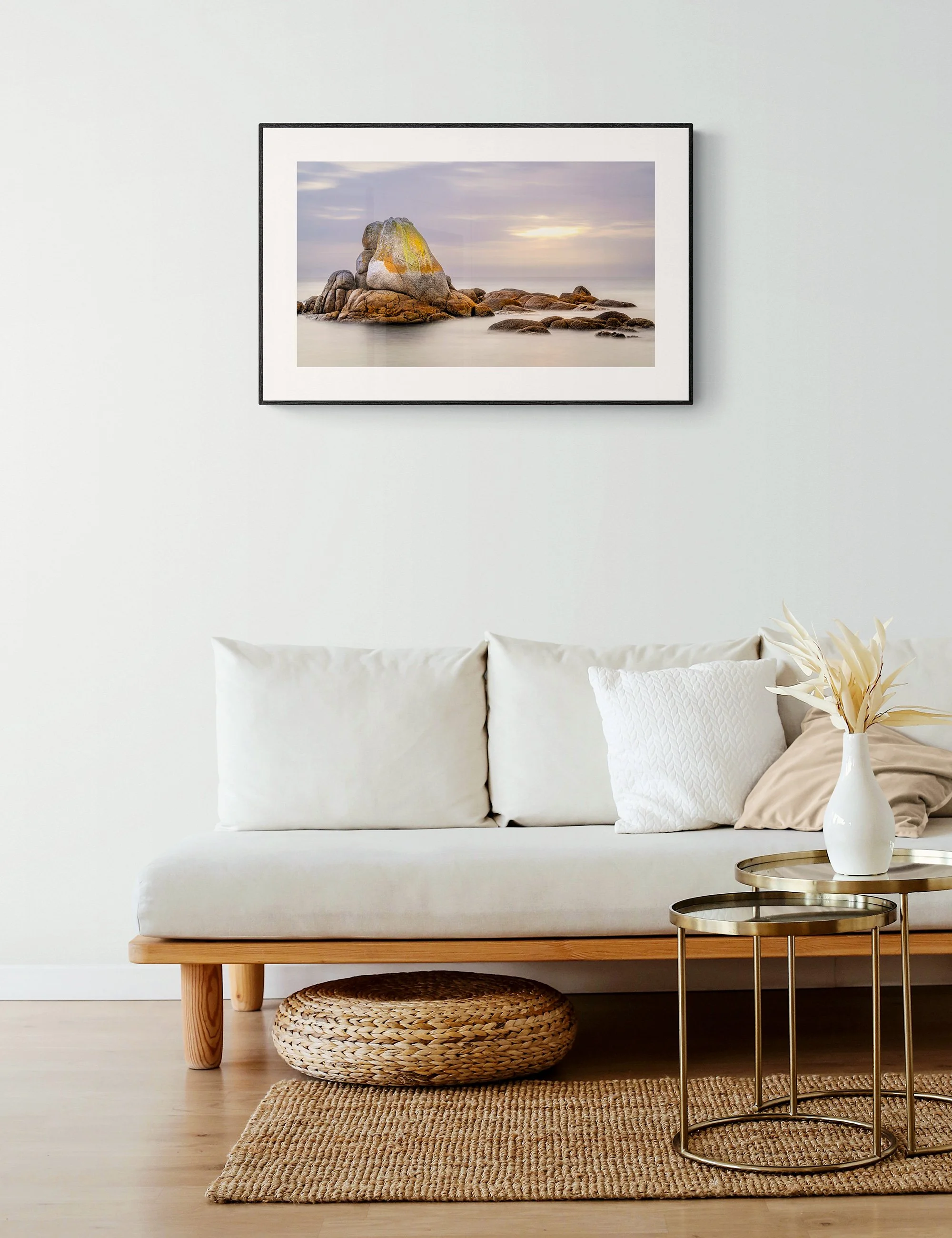 "Sentinels of the Dawn" from the Secluded Shorelines series by Ian J. Muirhead Arts, displayed as a framed minimalist seascape print in a natural contemporary interior.