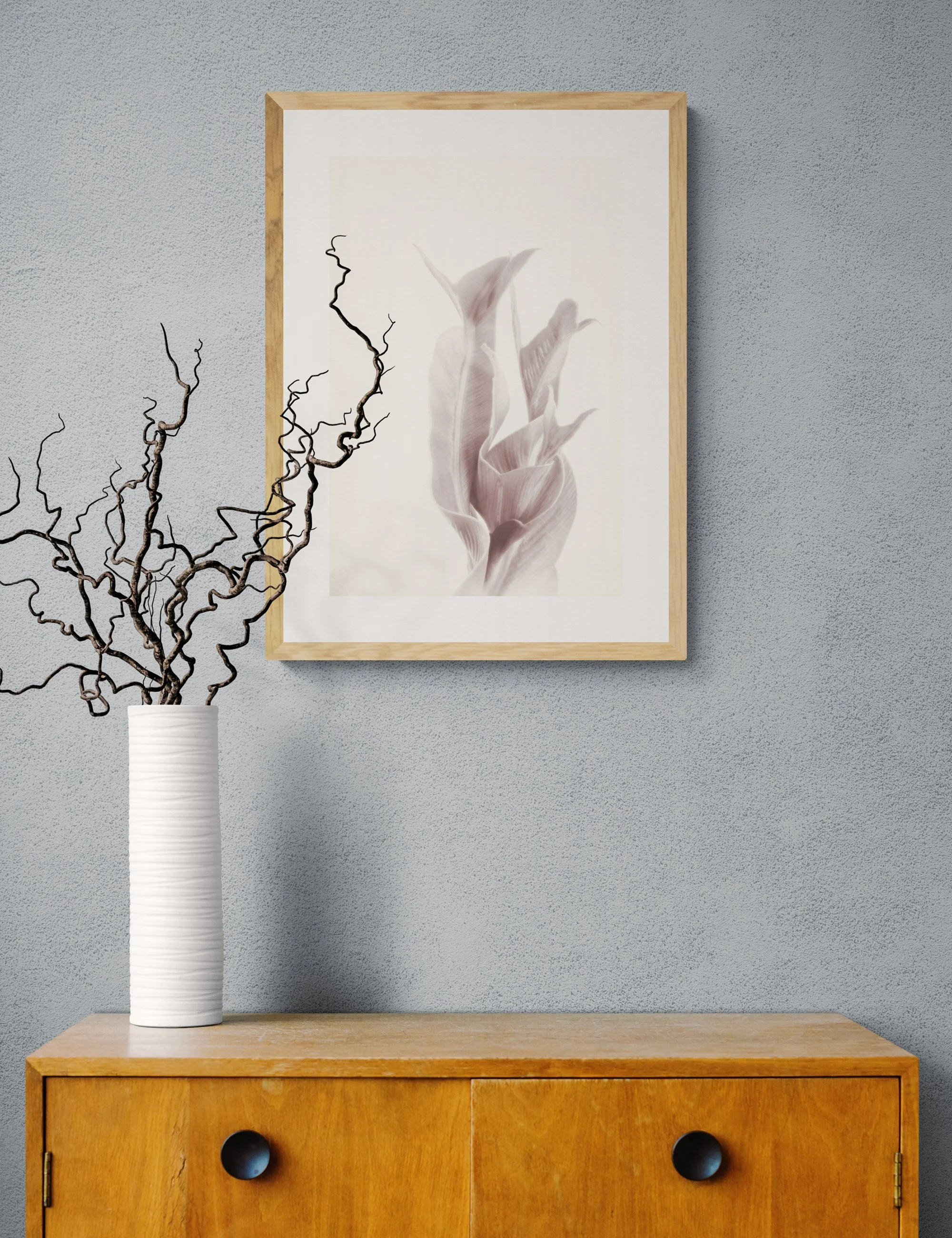 “Exultation" from the Fronded Forms fern series by Ian J. Muirhead Arts, displayed in a minimalist interior with a light timber frame and sculptural branches.