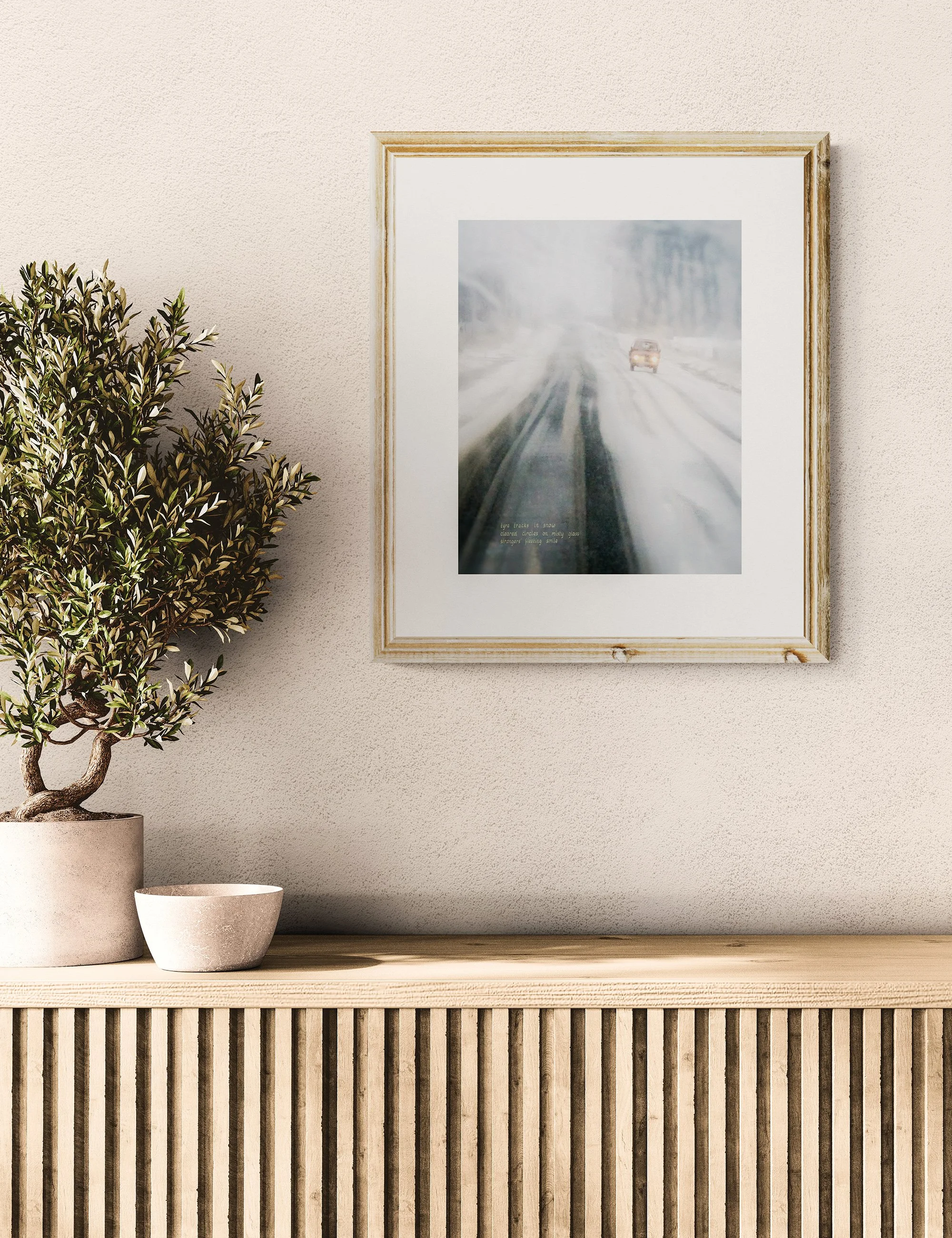 “STRANGERS IN SNOW” haiga print by Ian J. Muirhead Arts, featuring a blurred winter roadway scene with embedded haiku and atmospheric minimalist photography.