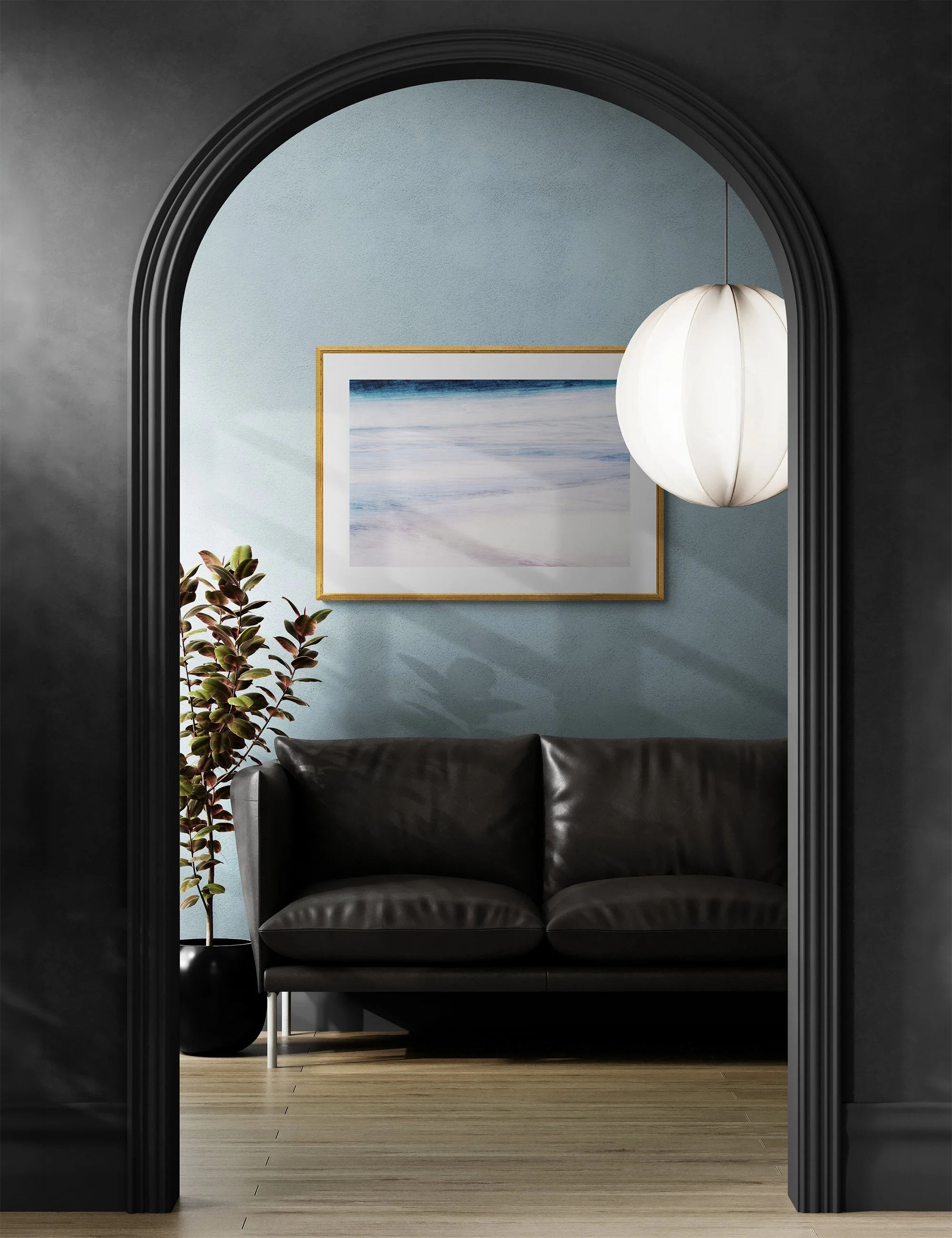 Framed coastal fine art print “Serene Swash” by Ian J Muirhead displayed in a contemporary interior framed by a black archway.