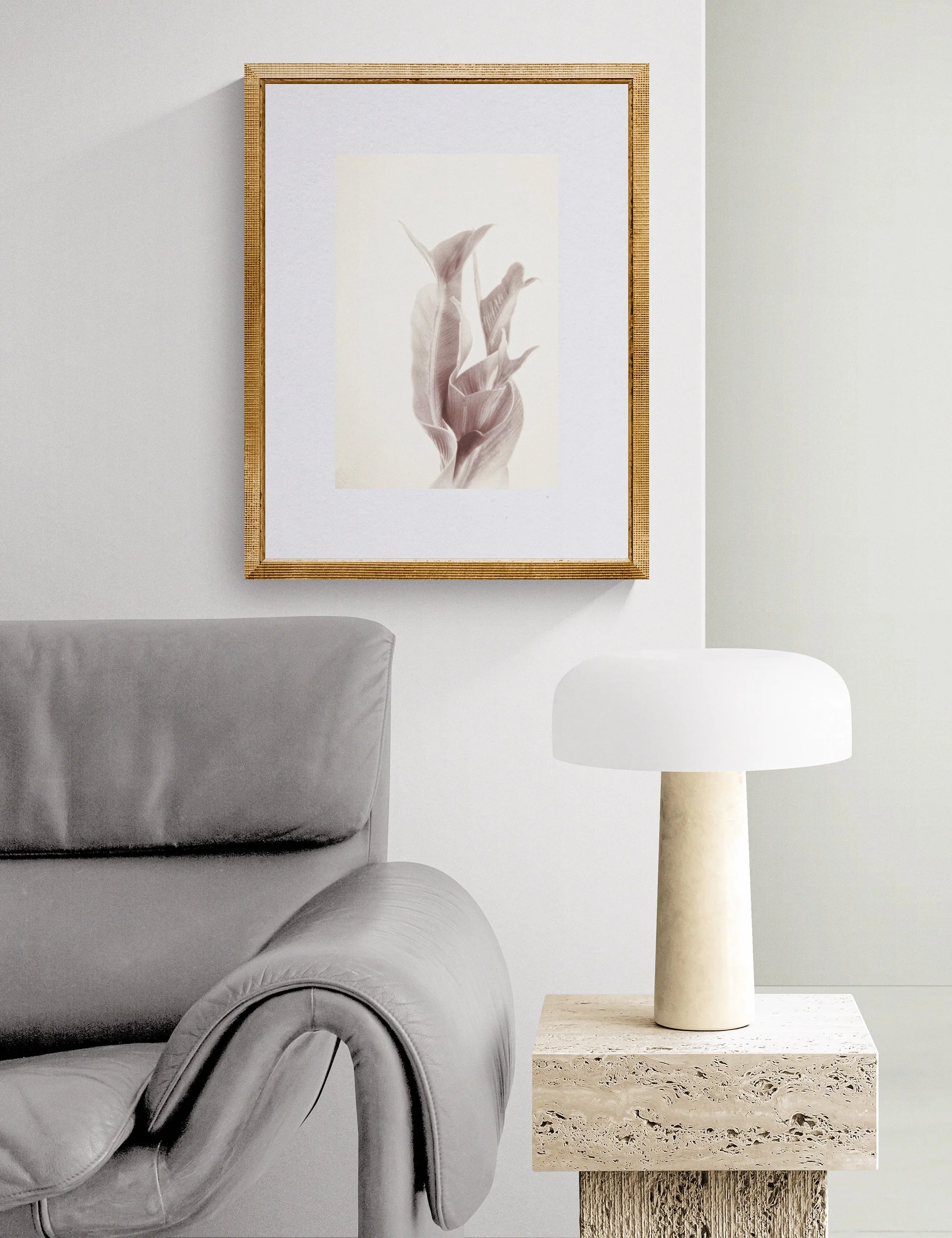 Fronded Forms limited edition botanical photograph by Ian J. Muirhead Arts, displayed in a contemporary reading corner with a sculptural lounge chair, stone side table and soft neutral tones.