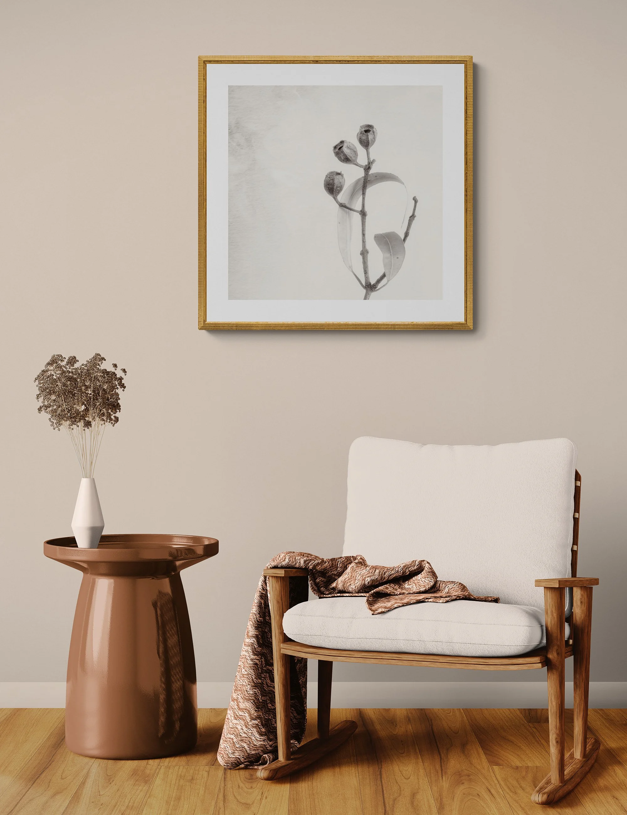 "Leaves Embrace" by Ian J Muirhead displayed as a framed botanical fine art print in a warm neutral contemporary interior with timber chair and side table.