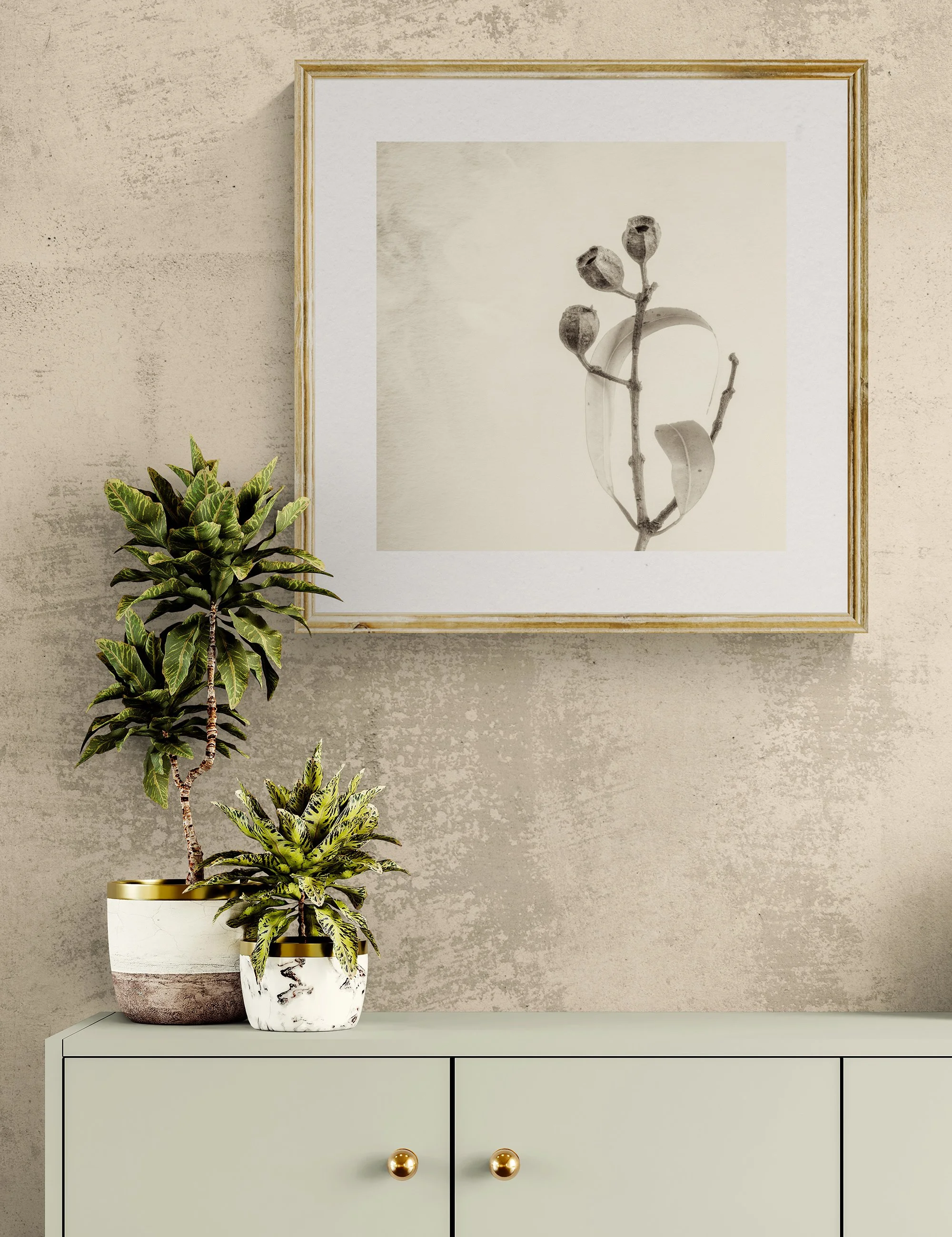 "Leaves Embrace" from the Gumnut Gestures series by Ian J. Muirhead Arts, displayed in a contemporary interior above a minimalist cabinet with botanical styling and a light timber frame.