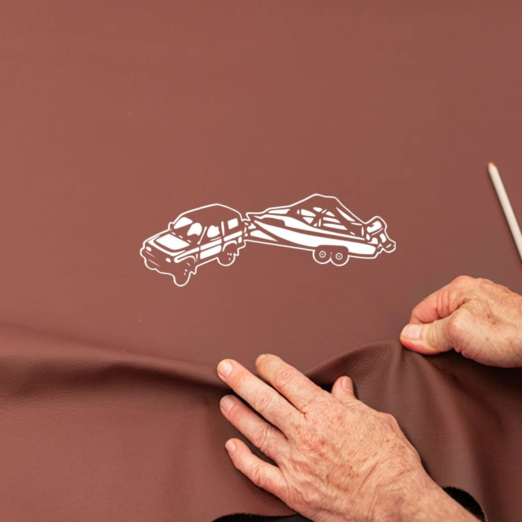 White line art drawing of a car crash on brown surface with hands pulling the surface back.