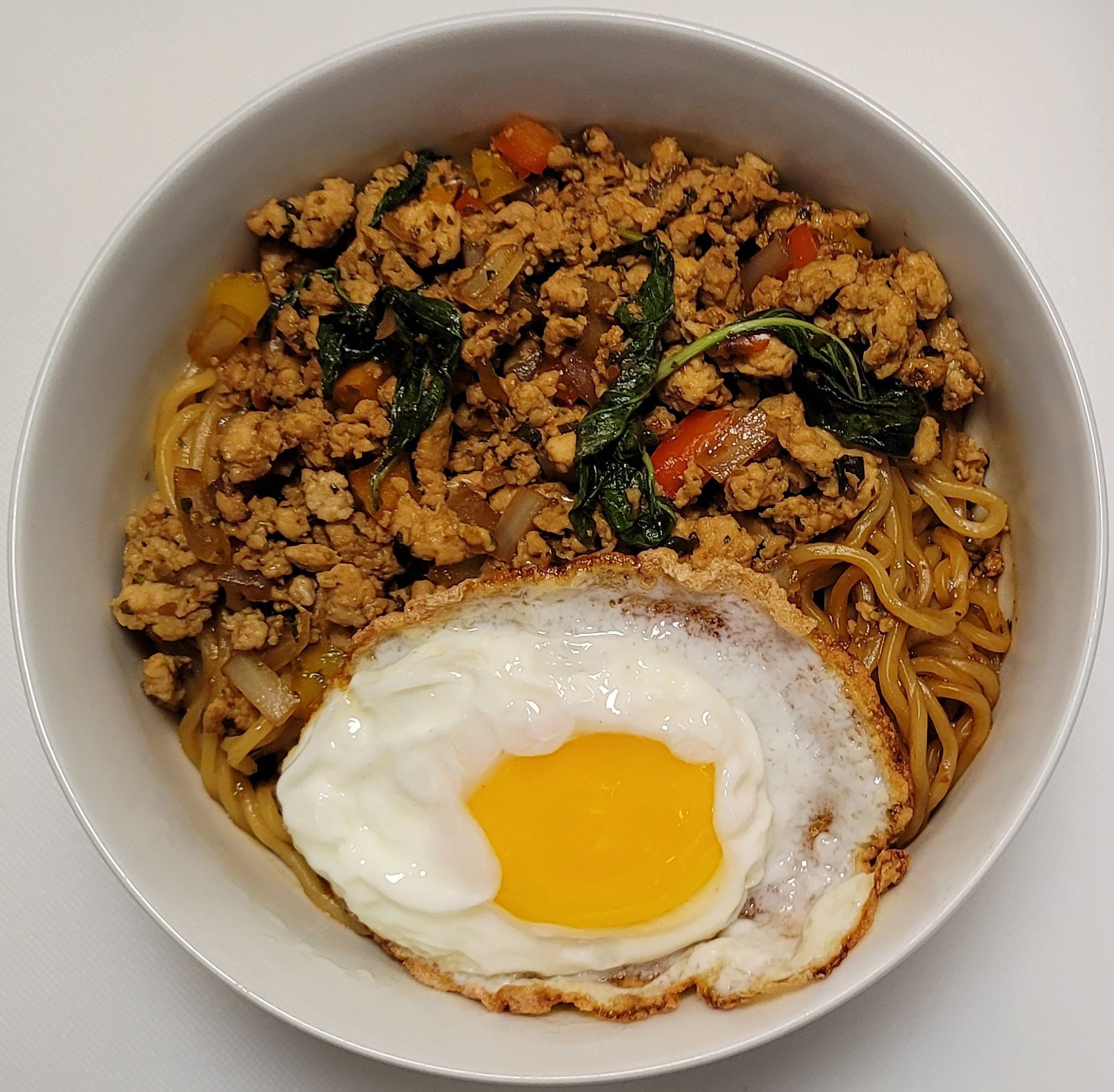 Our Thirsty Ramen &amp; Spicy Basil Chicken is one of our fusion dishes that started in the kitchen as a staff meal, it's a combo of our dry saucy ramen topped with spicy pad krapow style basil stir-fry with chicken, and we also add a Thai-style frie