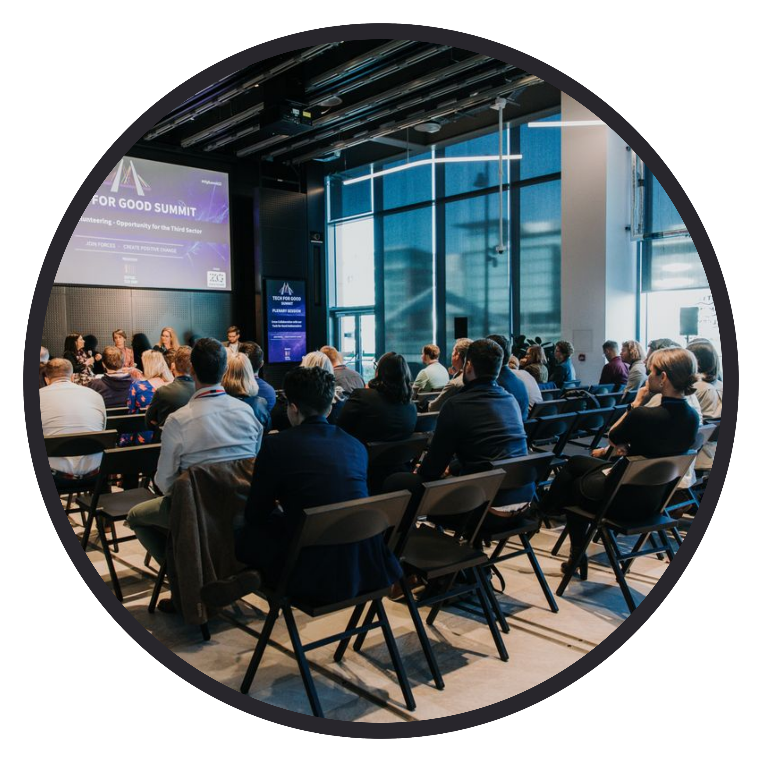 Circular image of people at a conference, facing a screen that says 'the tech for good summit