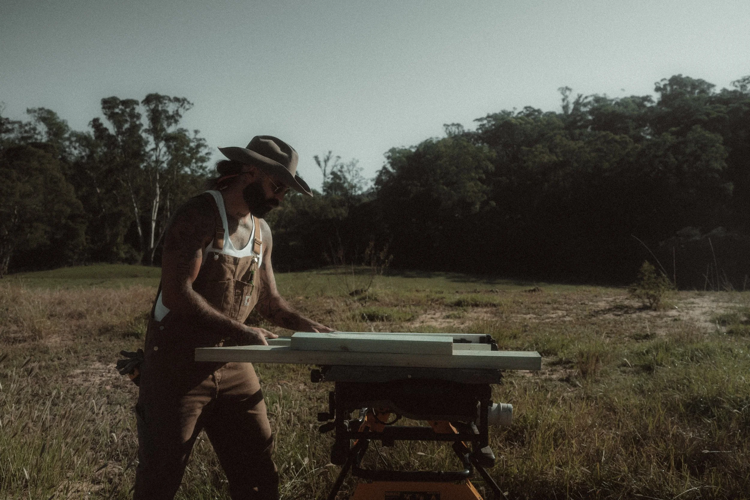FANDR craftsman working timber on a rural site at dusk