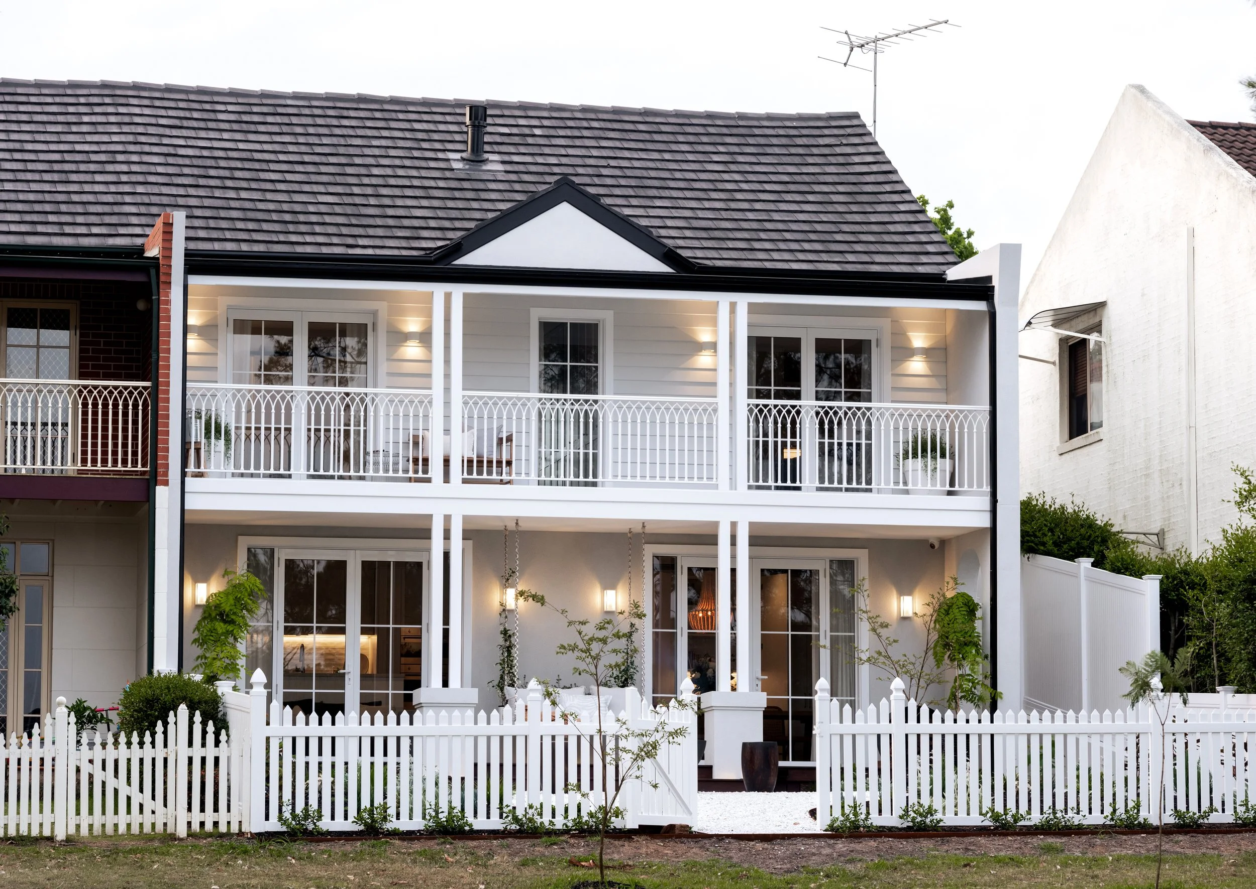 Two-storey home with balconies and picket fence built by FANDR in Bella Vista NSW