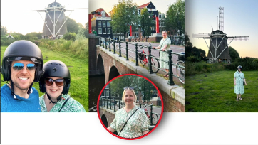 Group of people sightseeing in a city with windmills, bridges, and waterways.