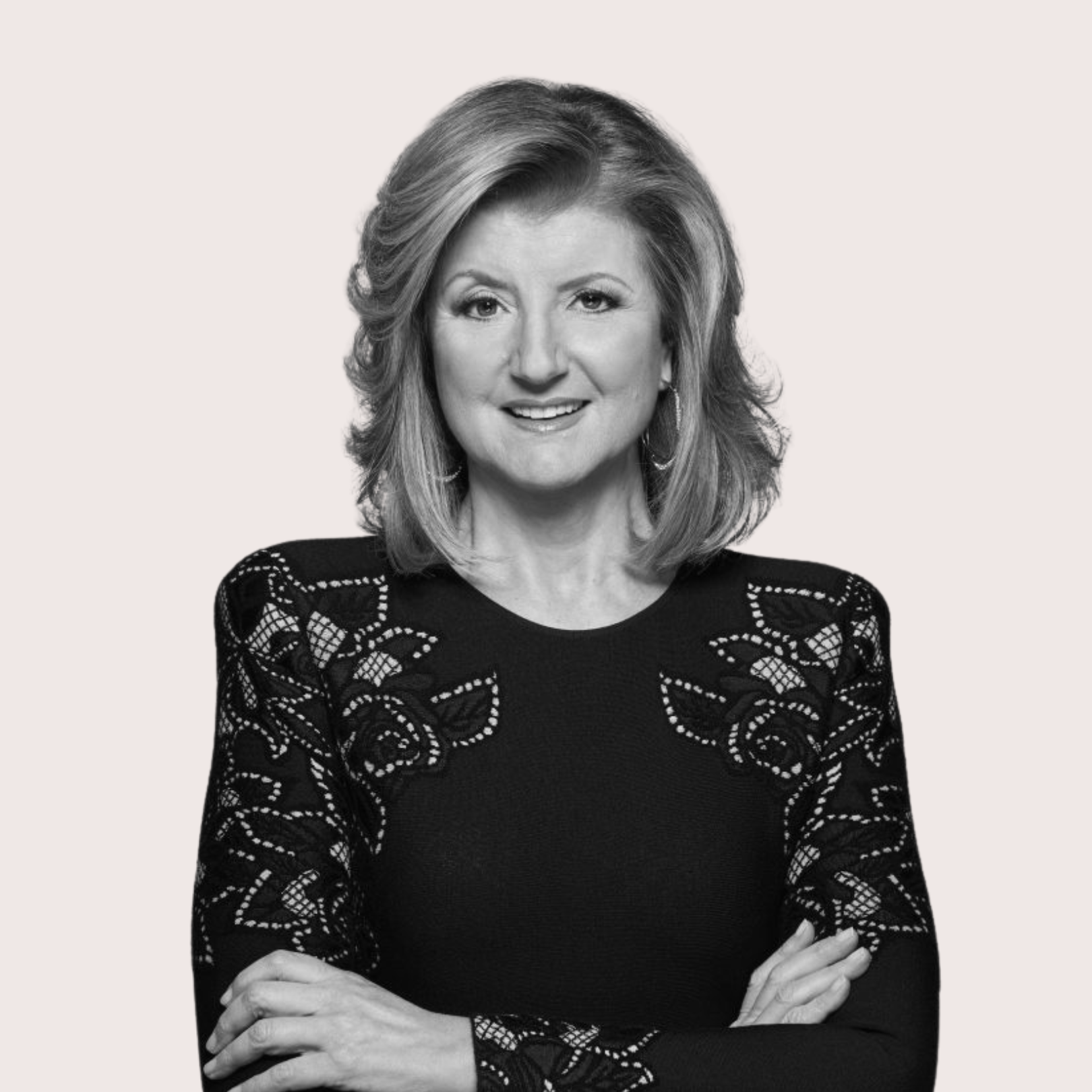 Black and white portrait of a middle-aged woman with shoulder-length hair wearing a black top with lace-like embroidery on the sleeves and shoulders, smiling with arms crossed. Best confidence self esteem training program for women