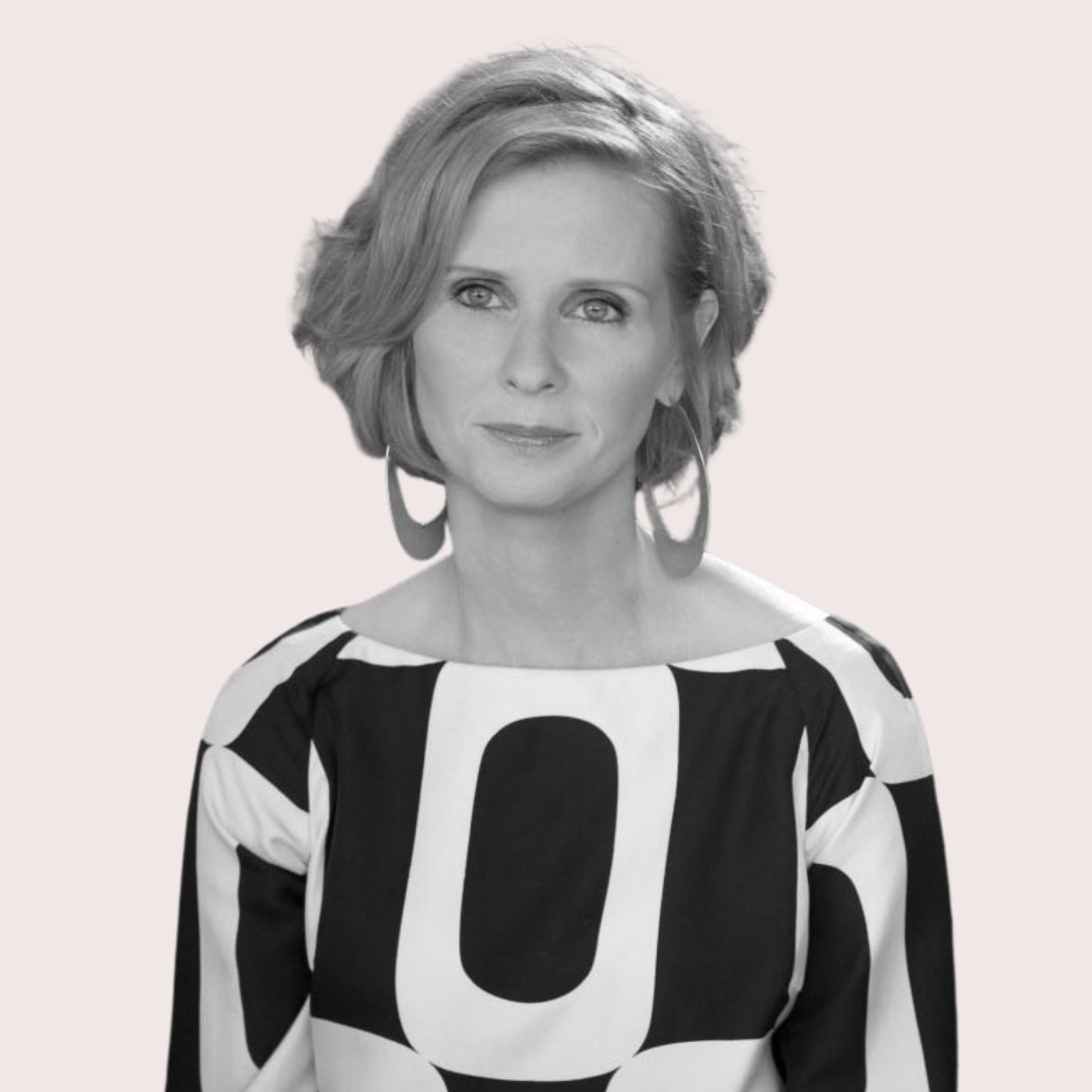 Black and white portrait of a woman with short wavy hair wearing large hoop earrings and a patterned top with large black and white shapes. Best confidence self esteem training program for women