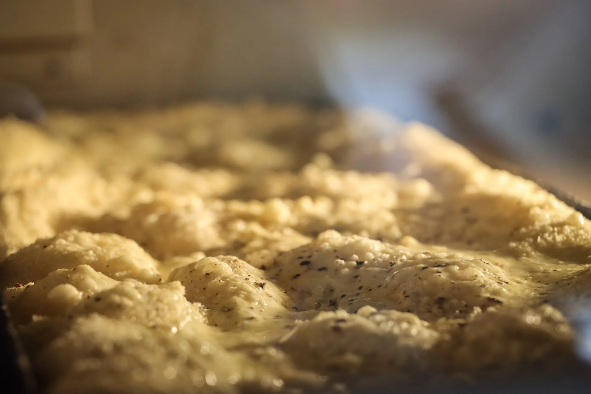 Close-up of raw chicken seasoned with herbs on a baking sheet