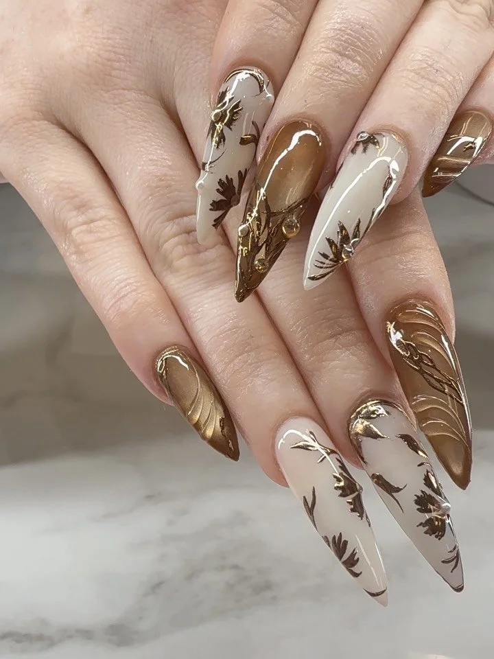 Nail technician applying gel nails to a client's fingernails using a UV lamp in a salon.