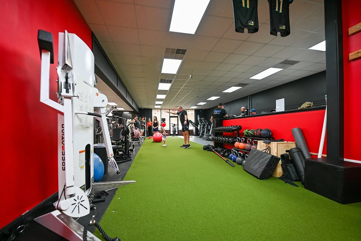 Indoor turf lane running through the Bern Fit training area