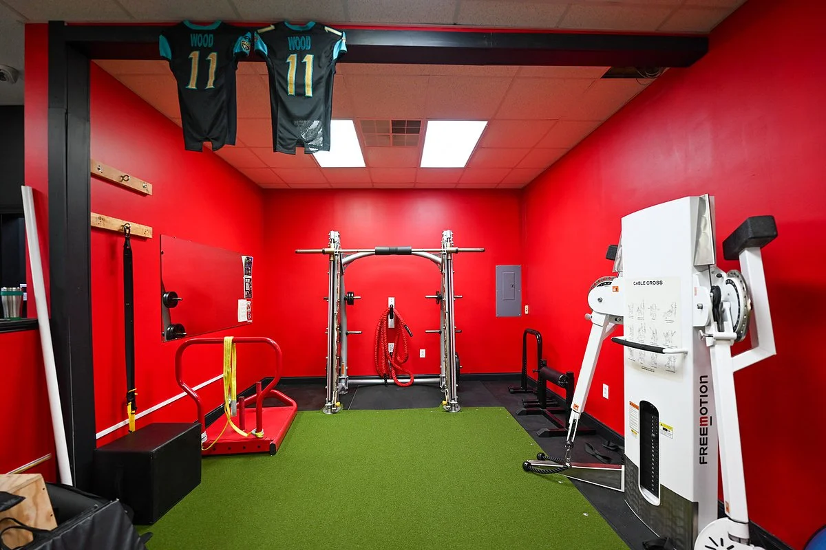Red-walled turf room with functional training equipment at Bern Fit