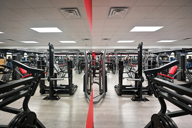 Rows of strength machines on the Bern Fit gym floor in New Bern, NC
