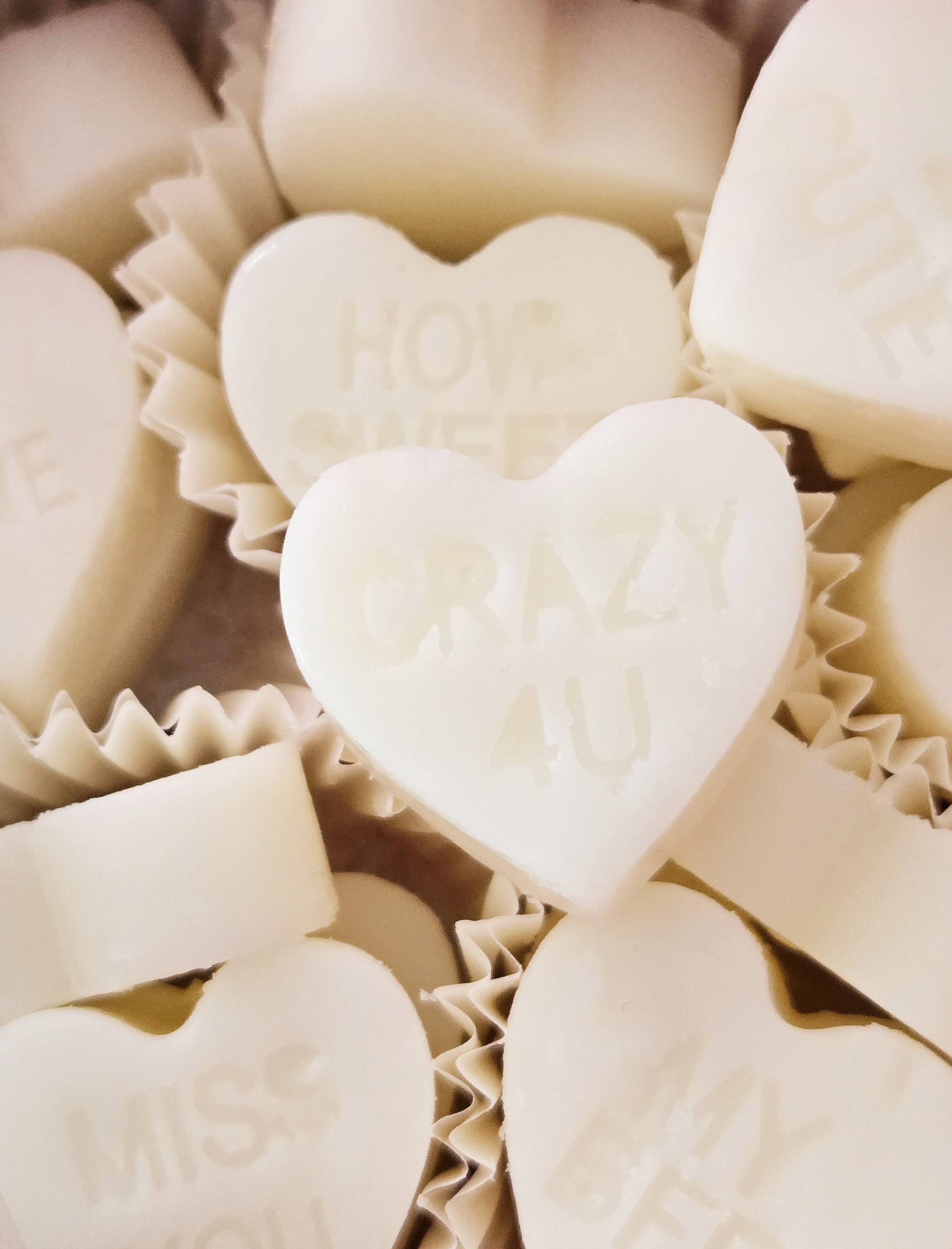 Heart-shaped wax melts with sweet messages, shown as custom-gifting inspiration.