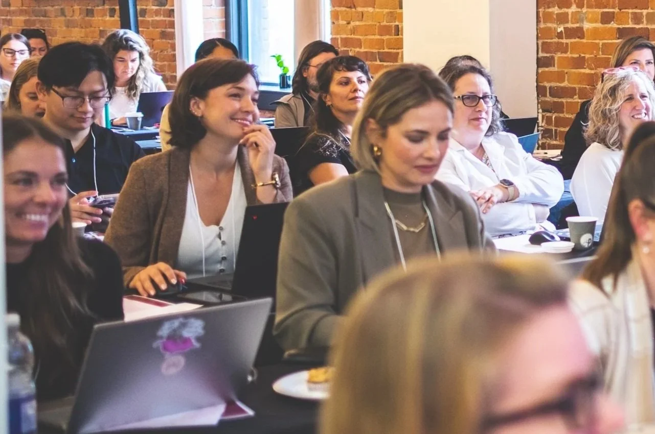 Audience at Asana on Tour smiling as they receive Asana Training delivered by Cirface