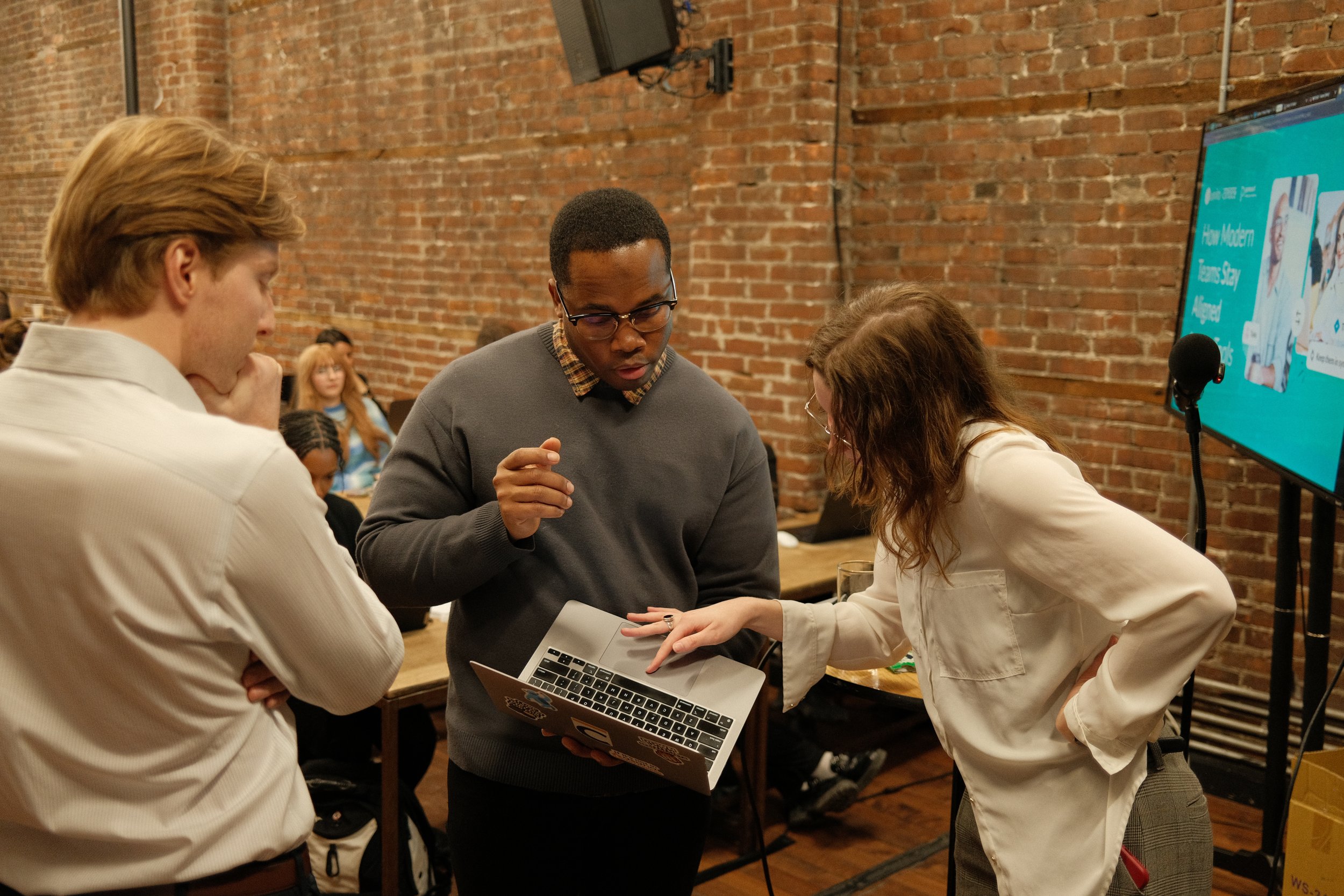 Marquis holding laptop with other team members