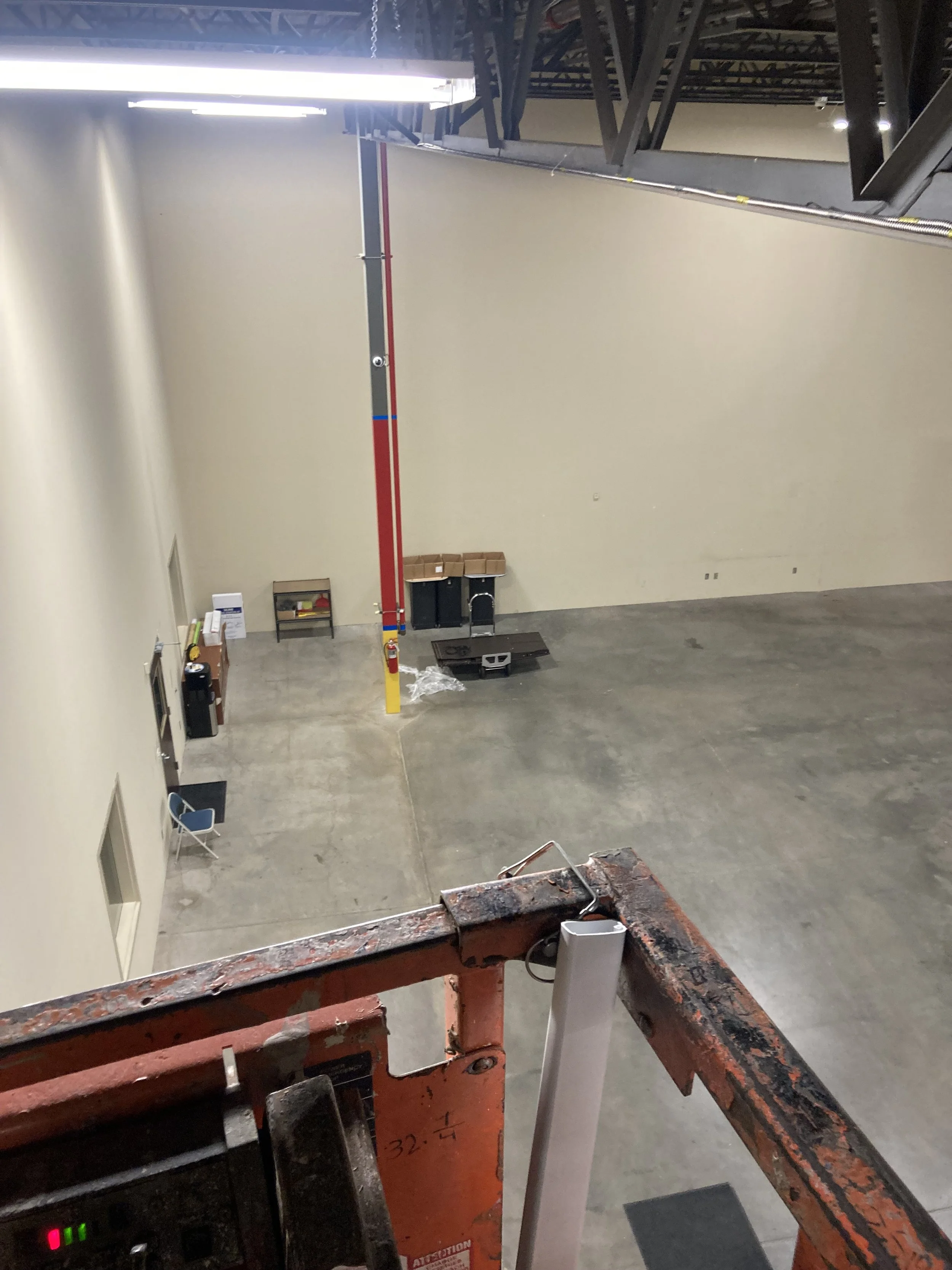A view of a warehouse from a scissor lift