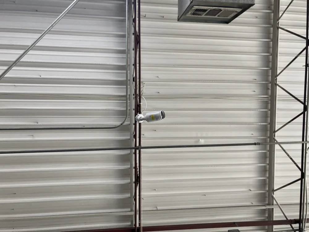 A security camera on a warehouse ceiling