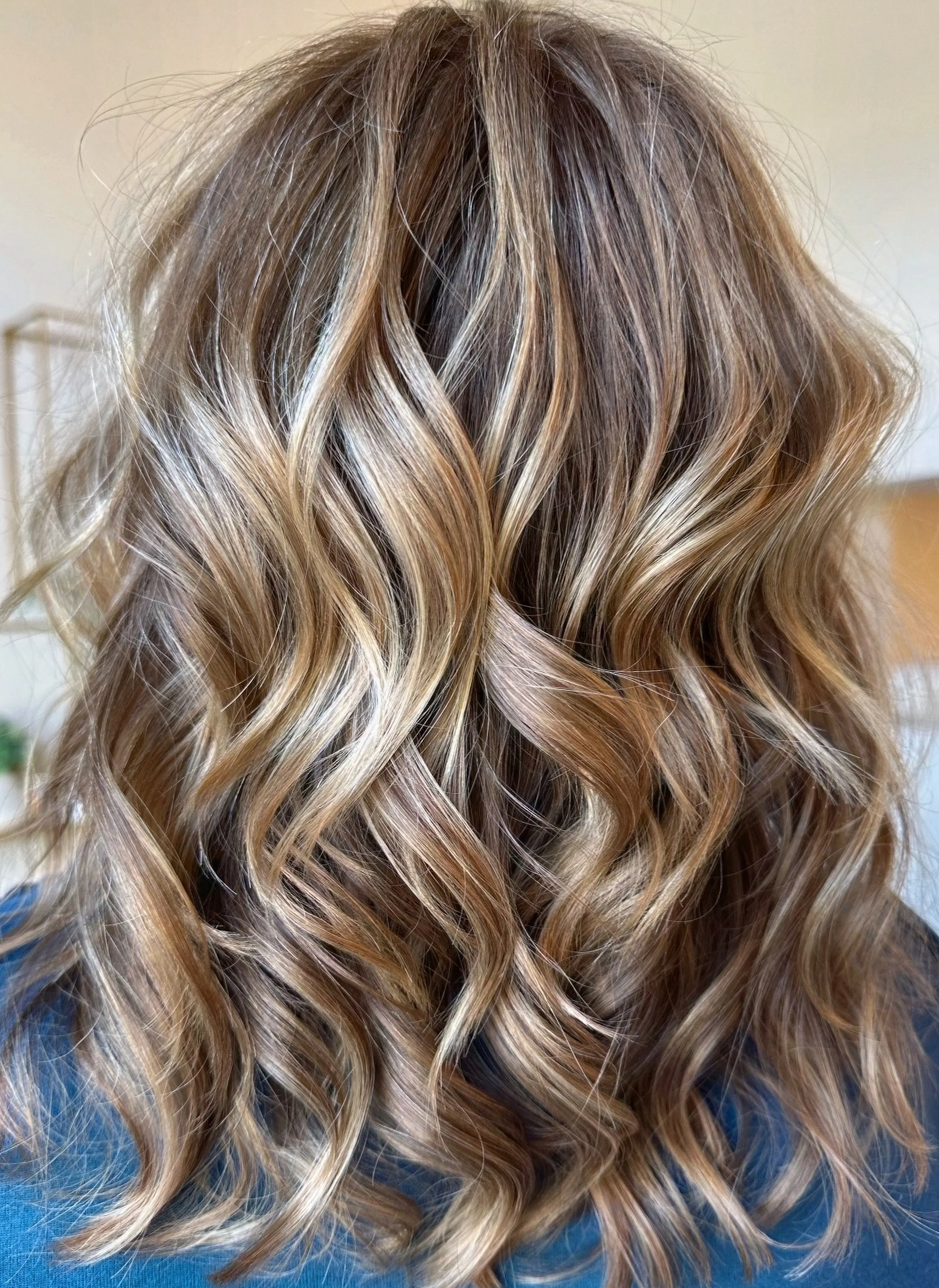 Back view of wavy, highlighted brunette hair