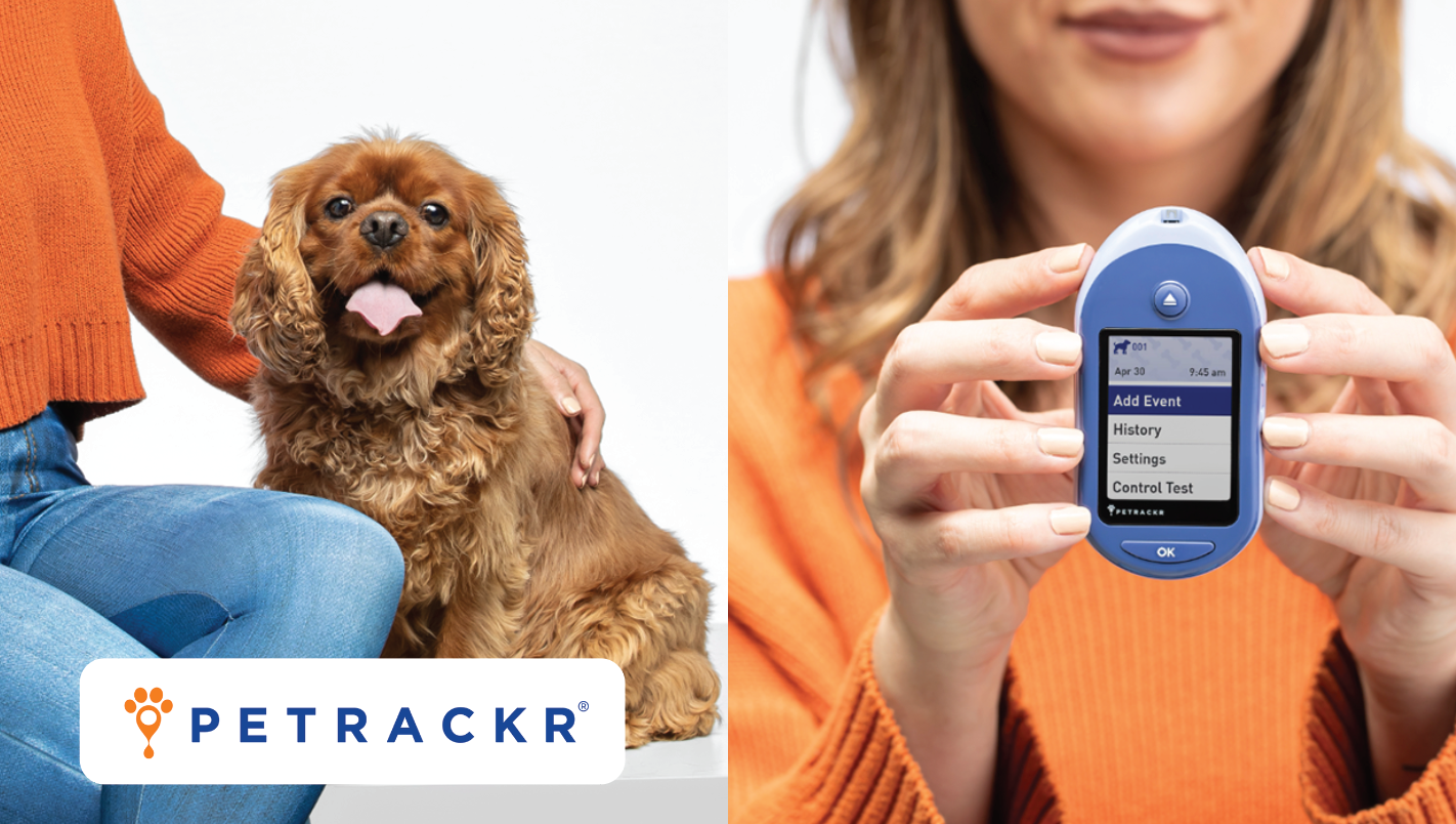A person in a rust-colored sweater holding a small brown poodle with curly fur and its tongue out, next to a woman holding a pet tracking device with a screen displaying options including add event, history, settings, and control test.