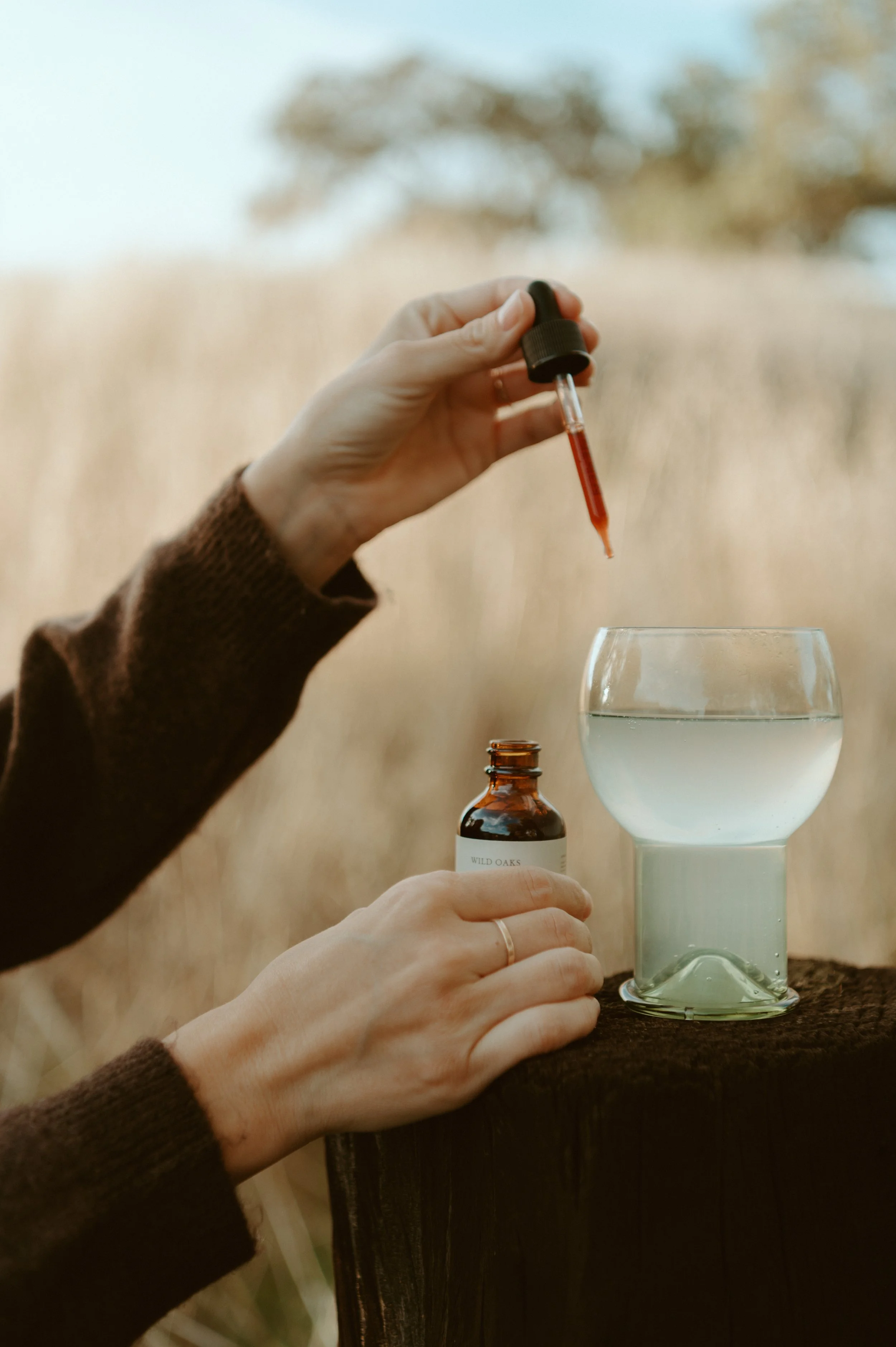 tincture dropper put in a glass outside